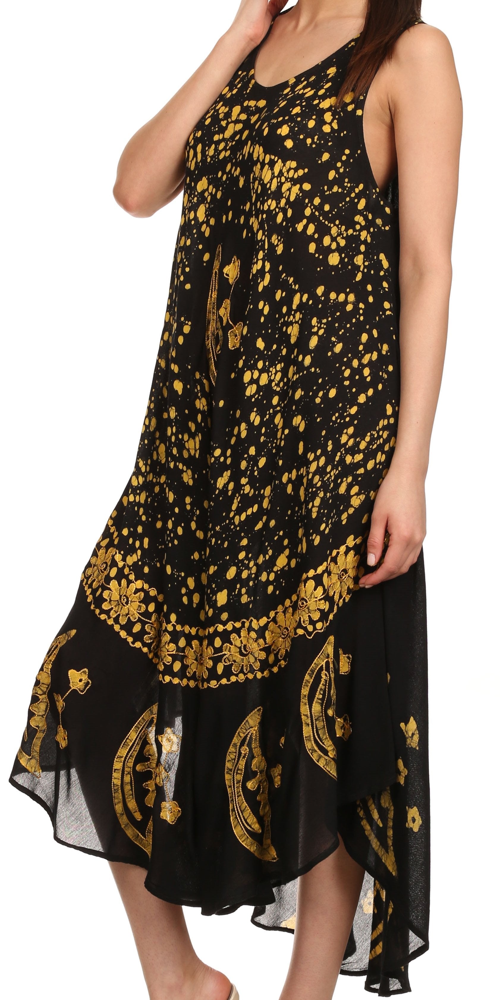 Black dress with gold floral patterns worn by a model on a white background