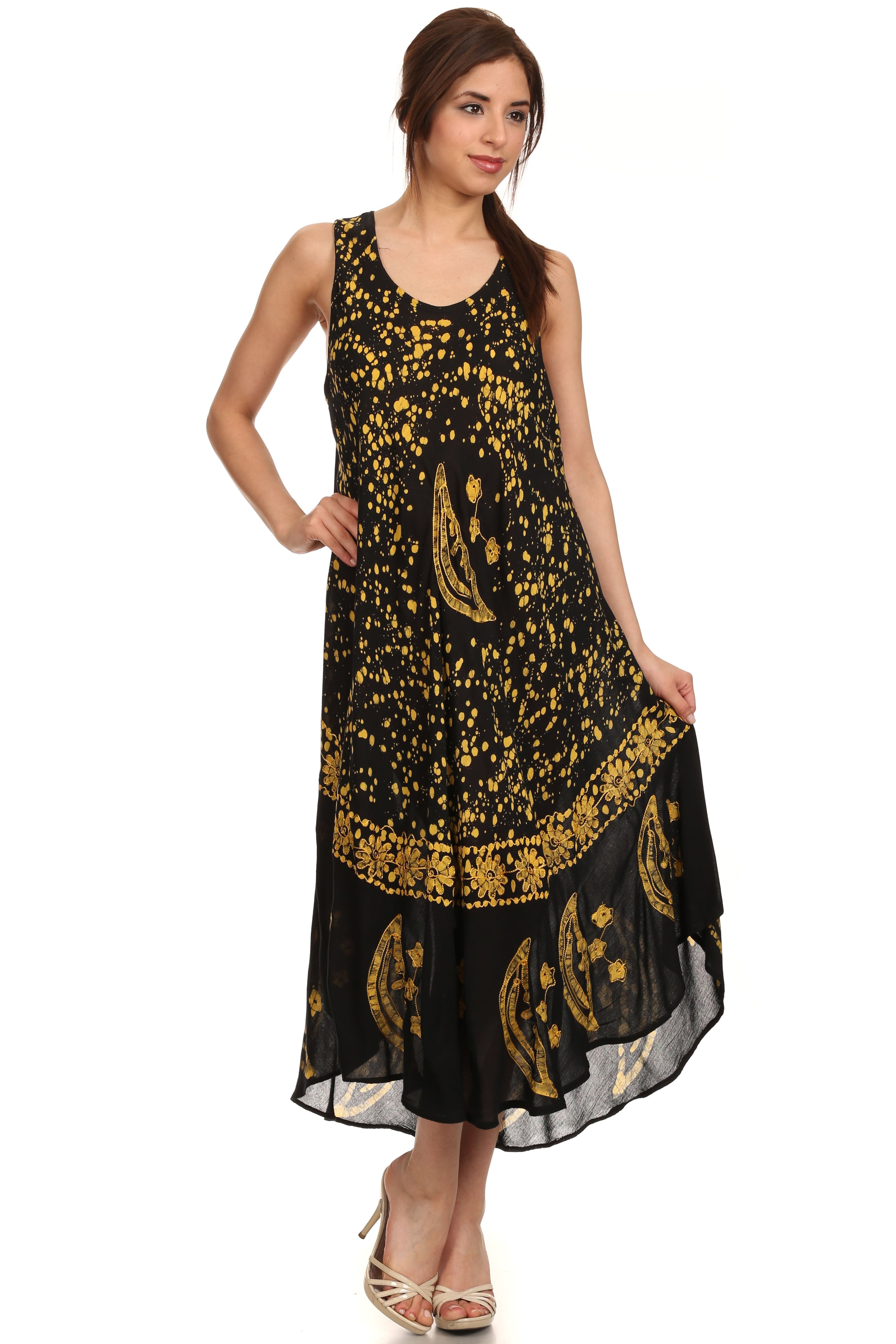 Woman wearing a black dress with gold patterns on a white background