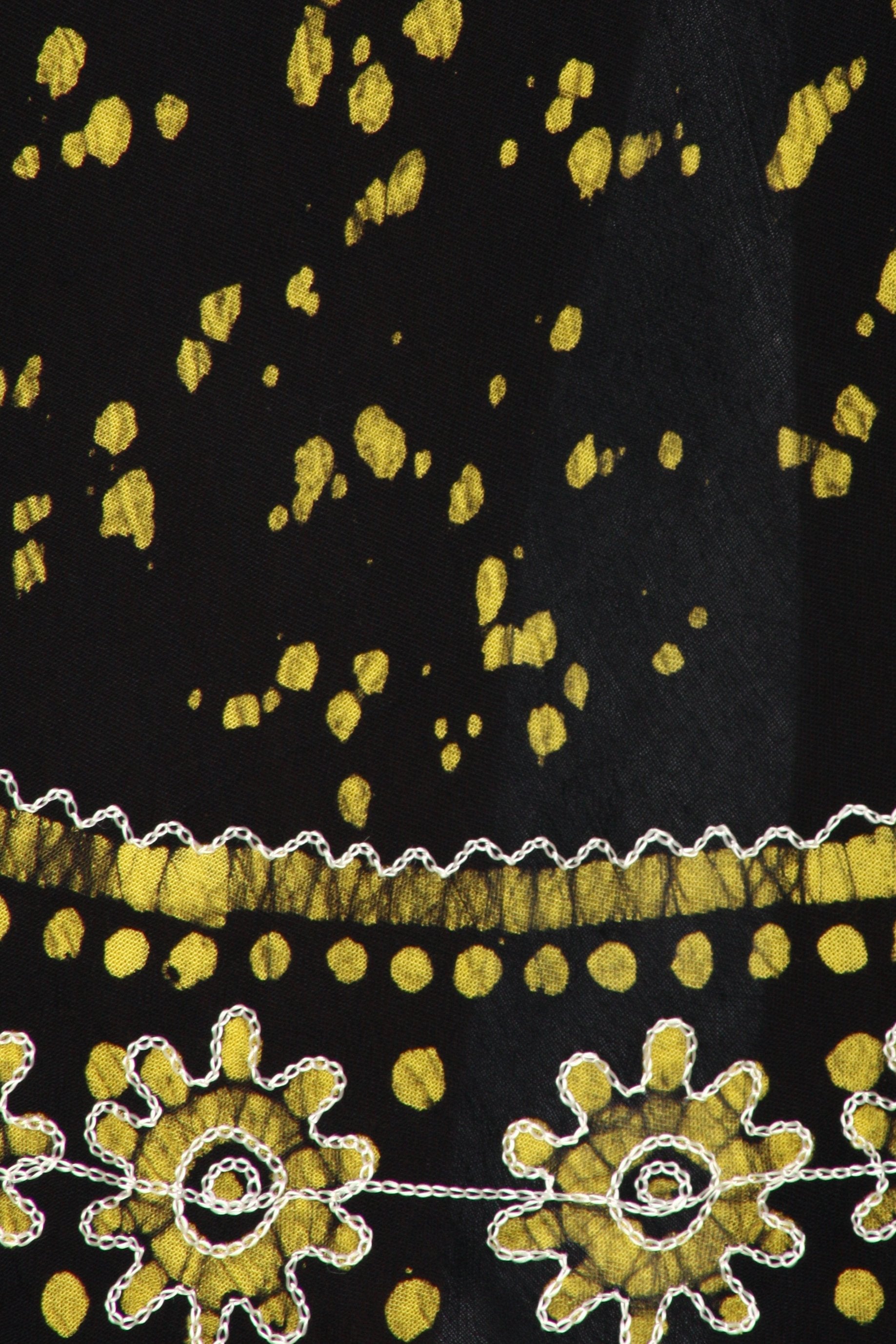 Black fabric with yellow floral patterns and white trim