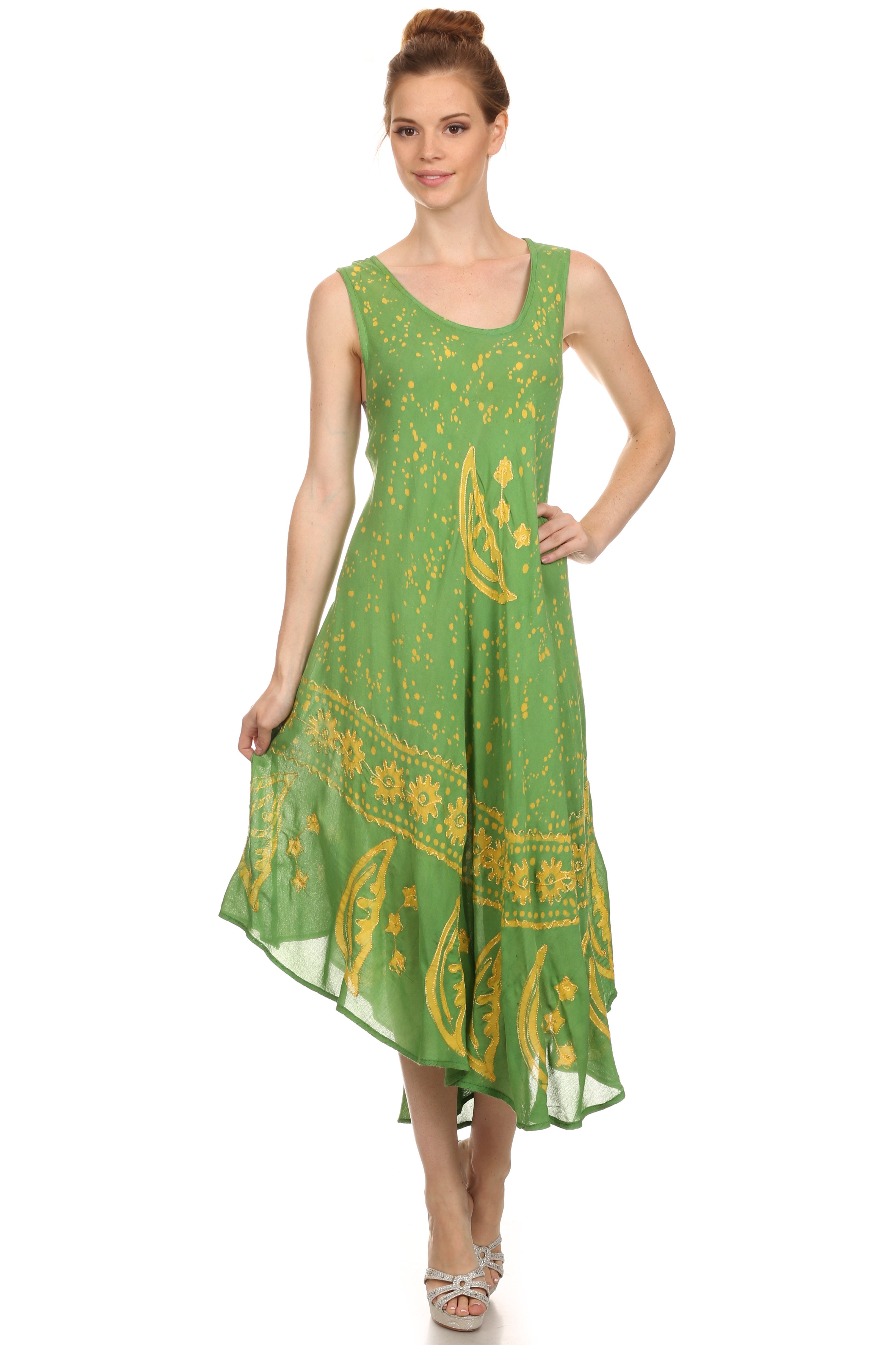 Woman wearing a green dress with yellow patterns on a white background