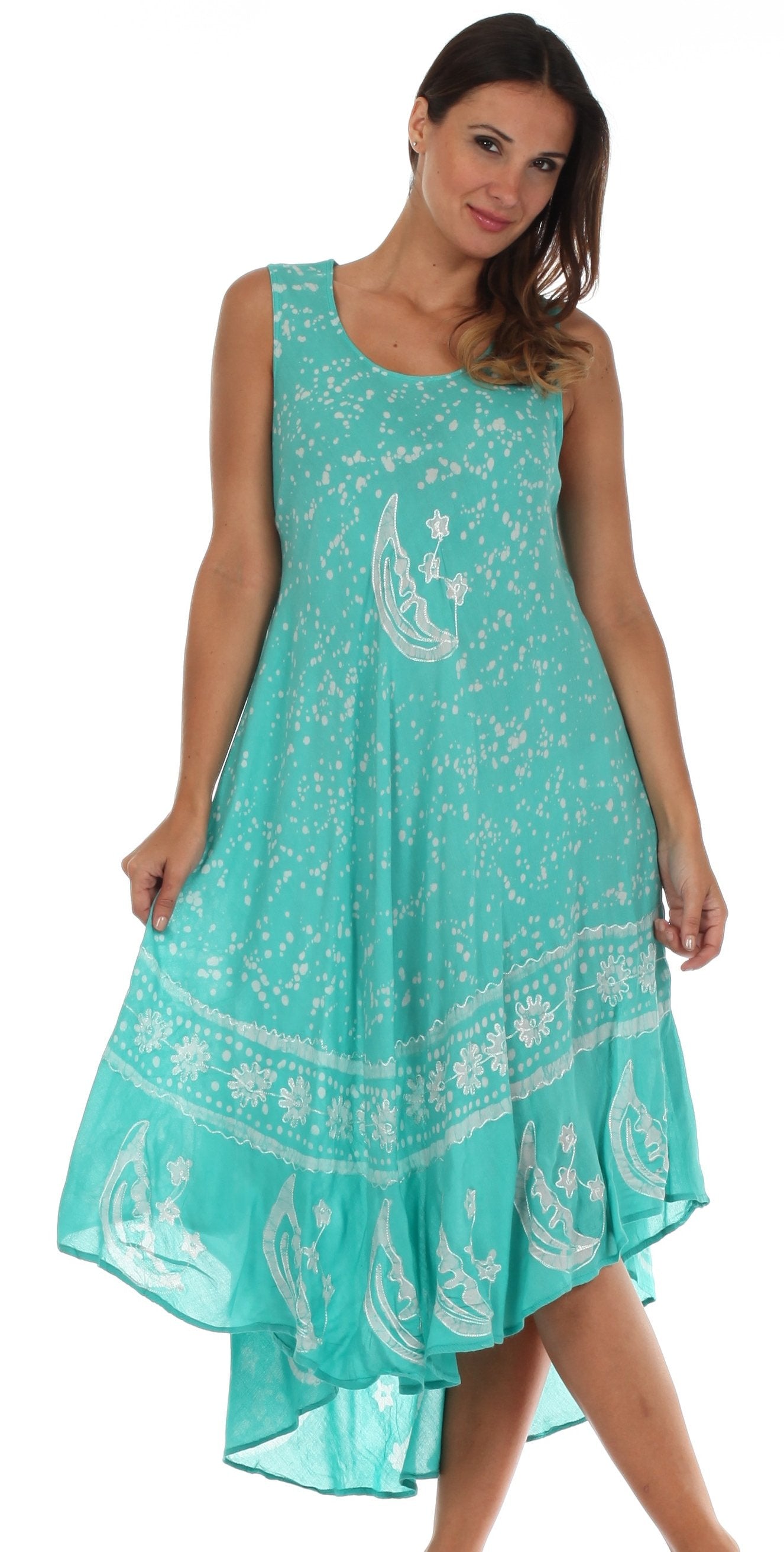 Woman wearing a turquoise dress with white patterns on a white background