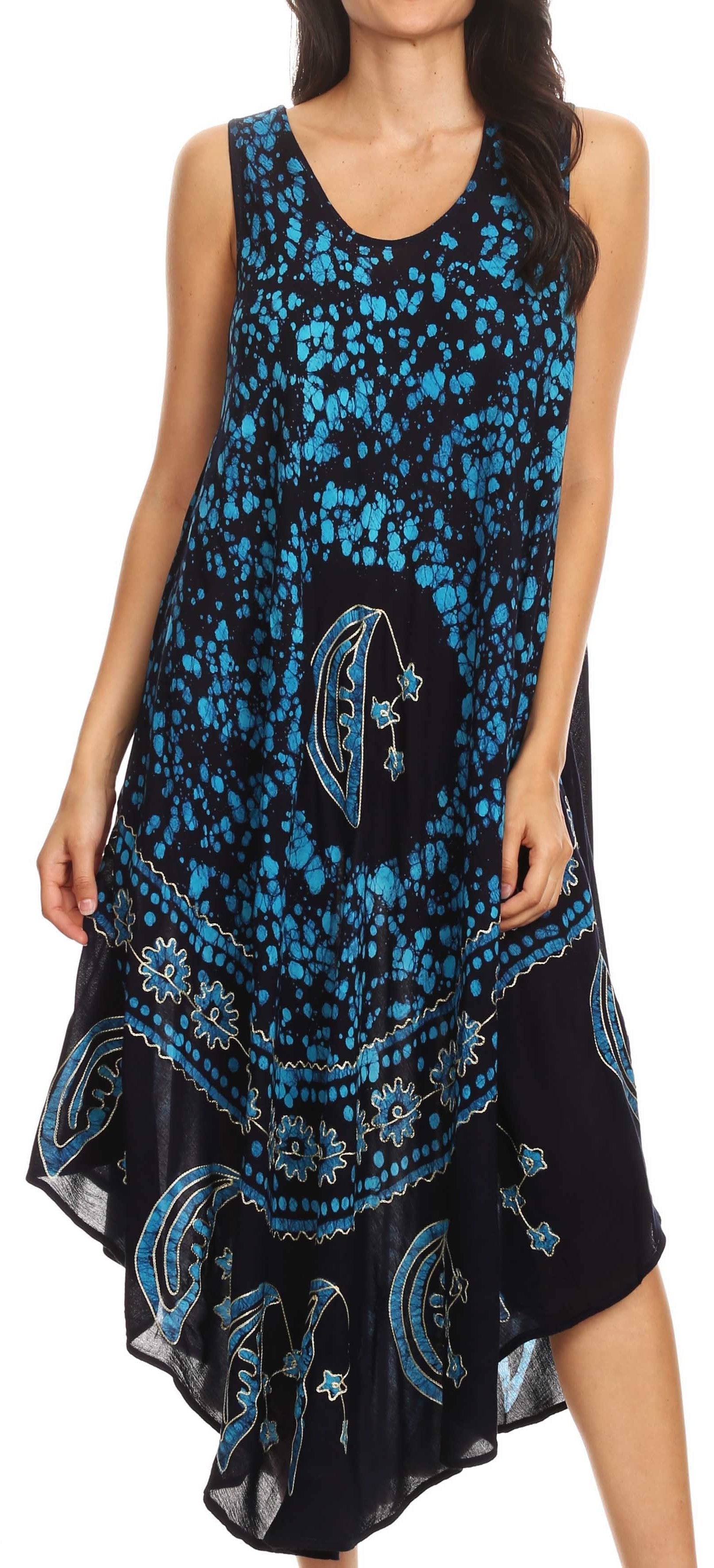 Woman wearing a black and blue floral dress with intricate patterns.
