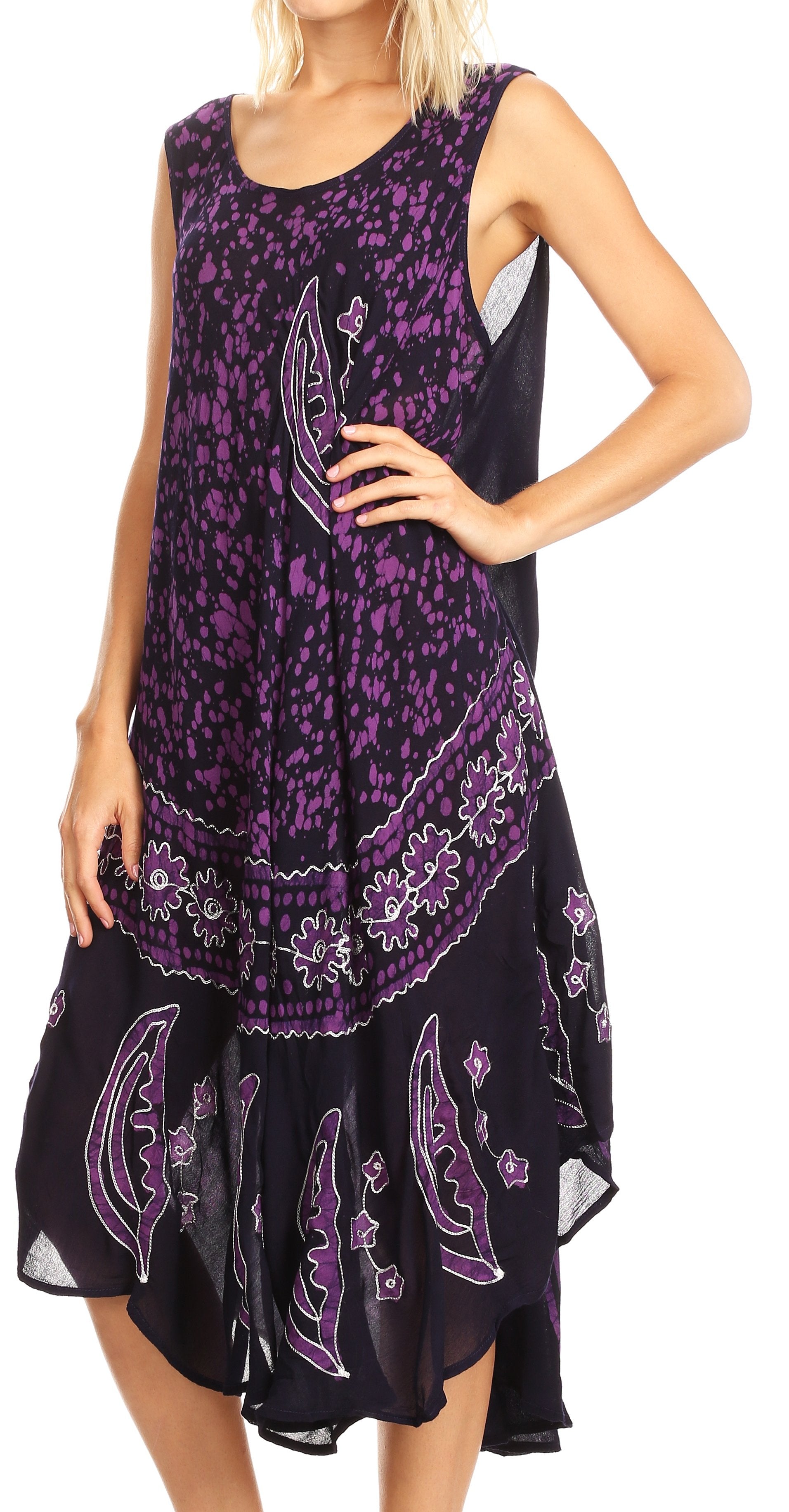 Woman wearing a sleeveless dress with purple floral patterns on a white background