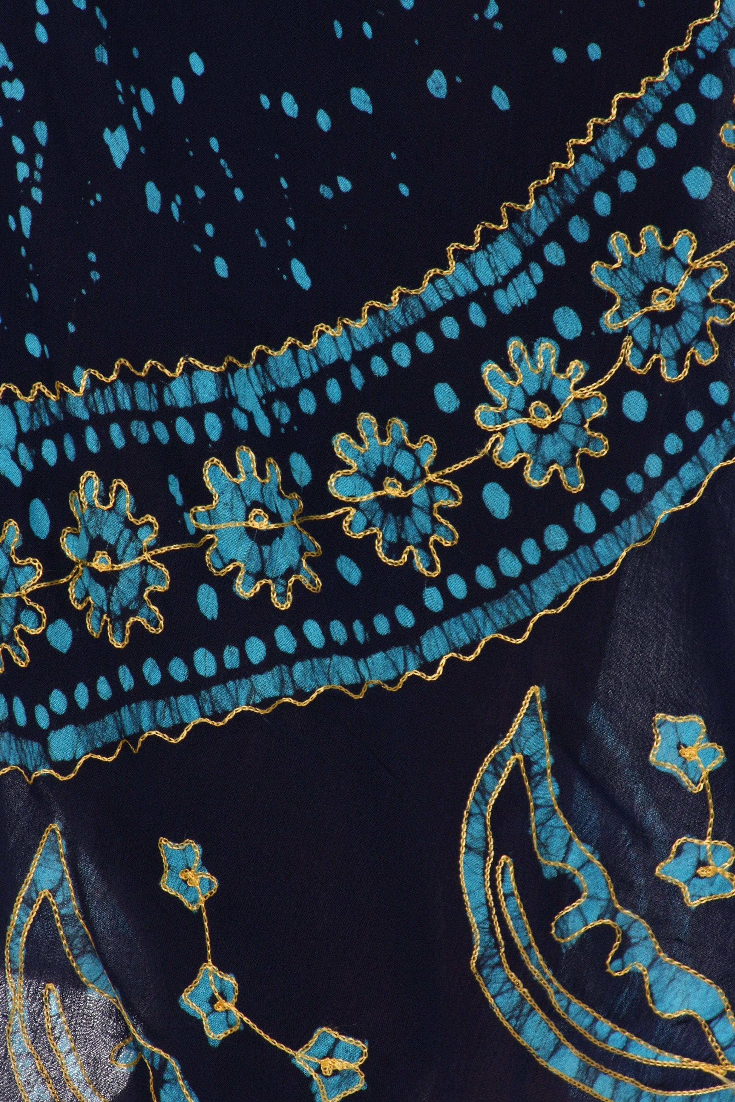 Close-up of a dark fabric with blue and gold embroidery