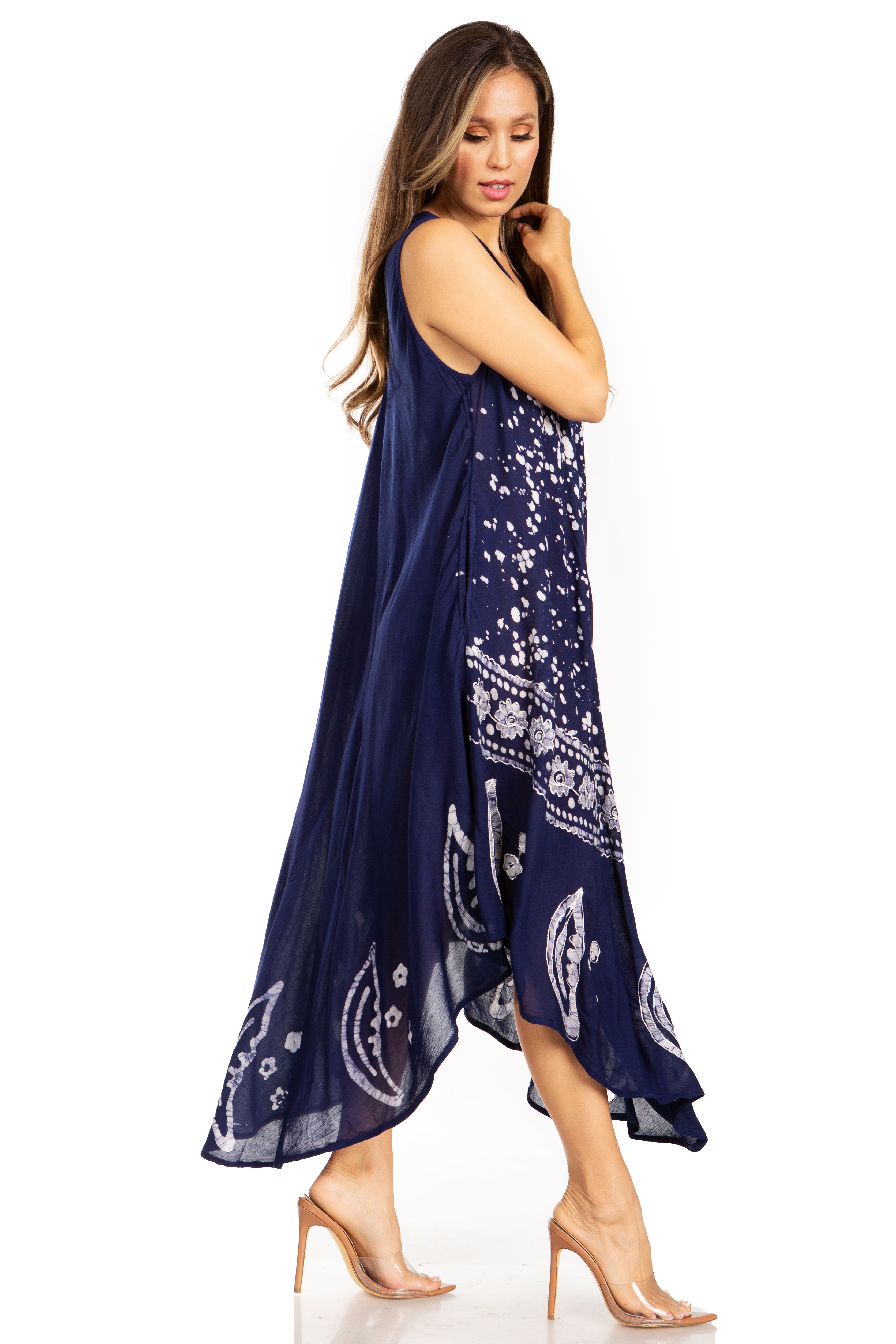 Woman wearing a navy blue dress with white patterns on a white background