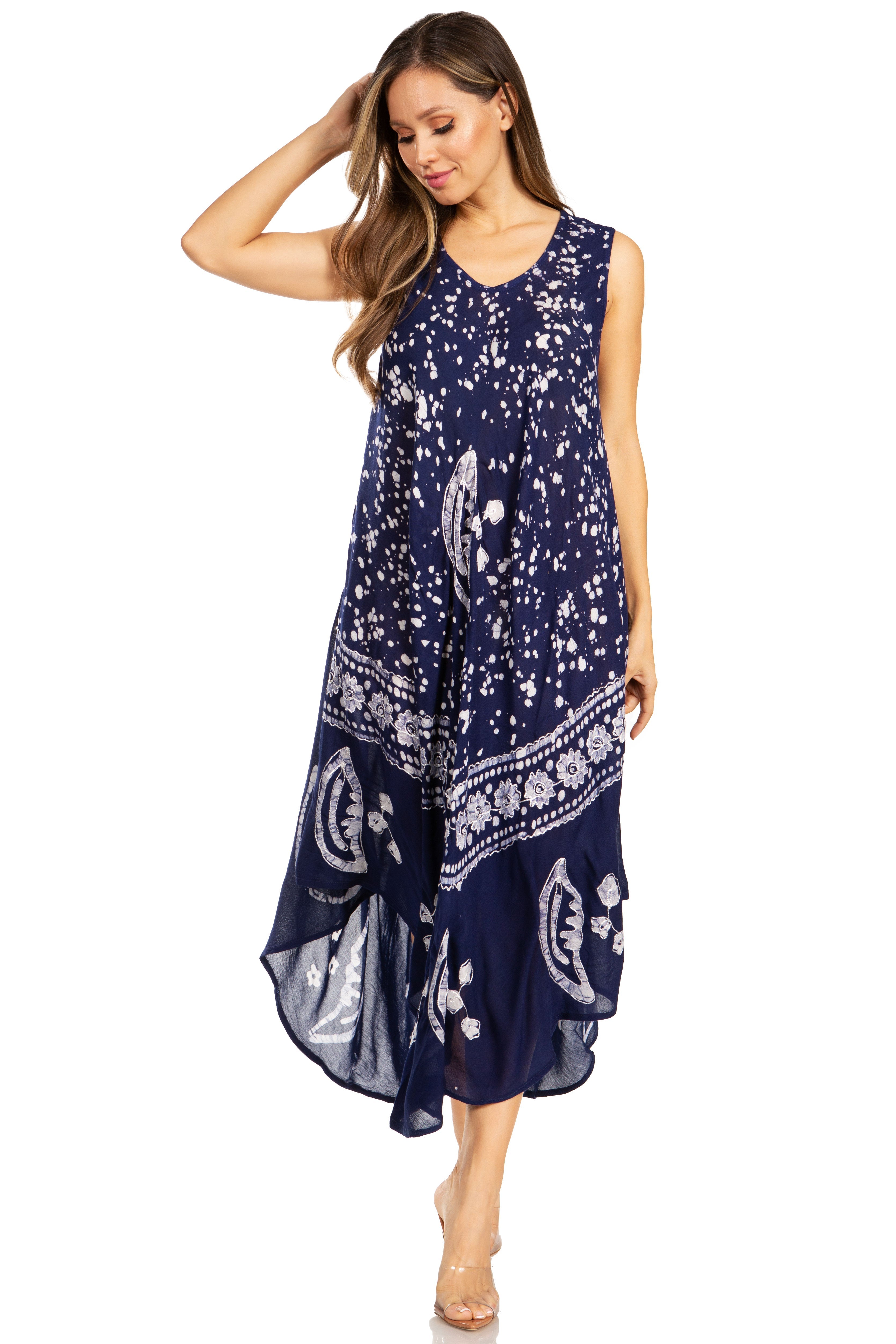 Woman wearing a navy blue dress with white patterns on a white background