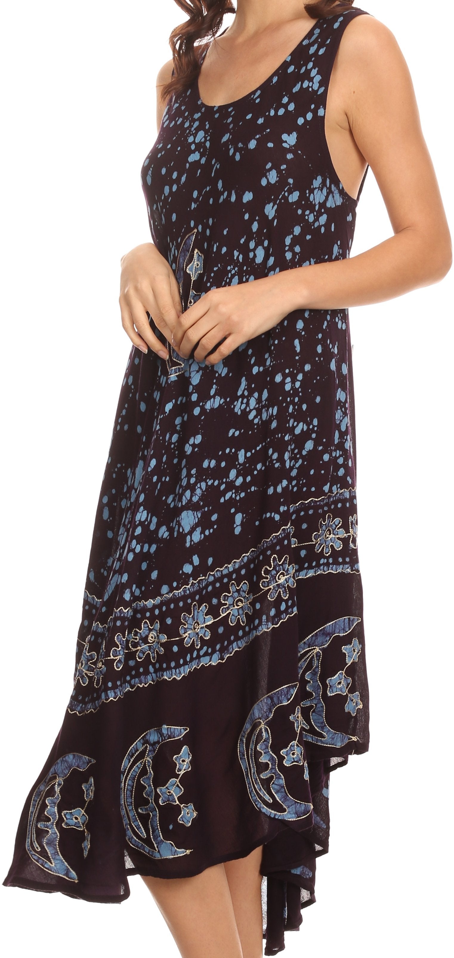 Woman wearing a black dress with blue floral patterns on a white background