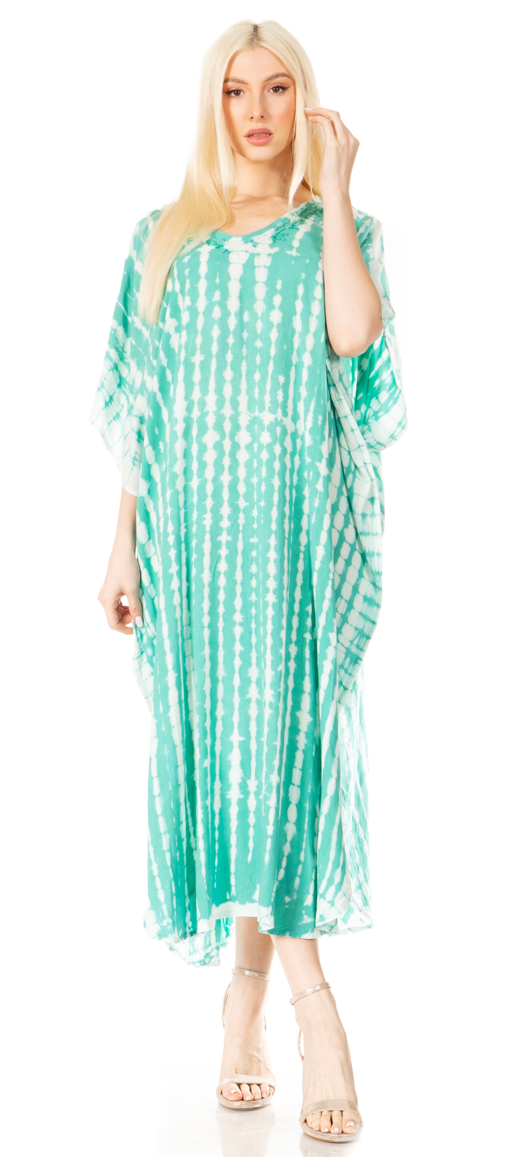 Woman wearing a green and white patterned dress on a white background