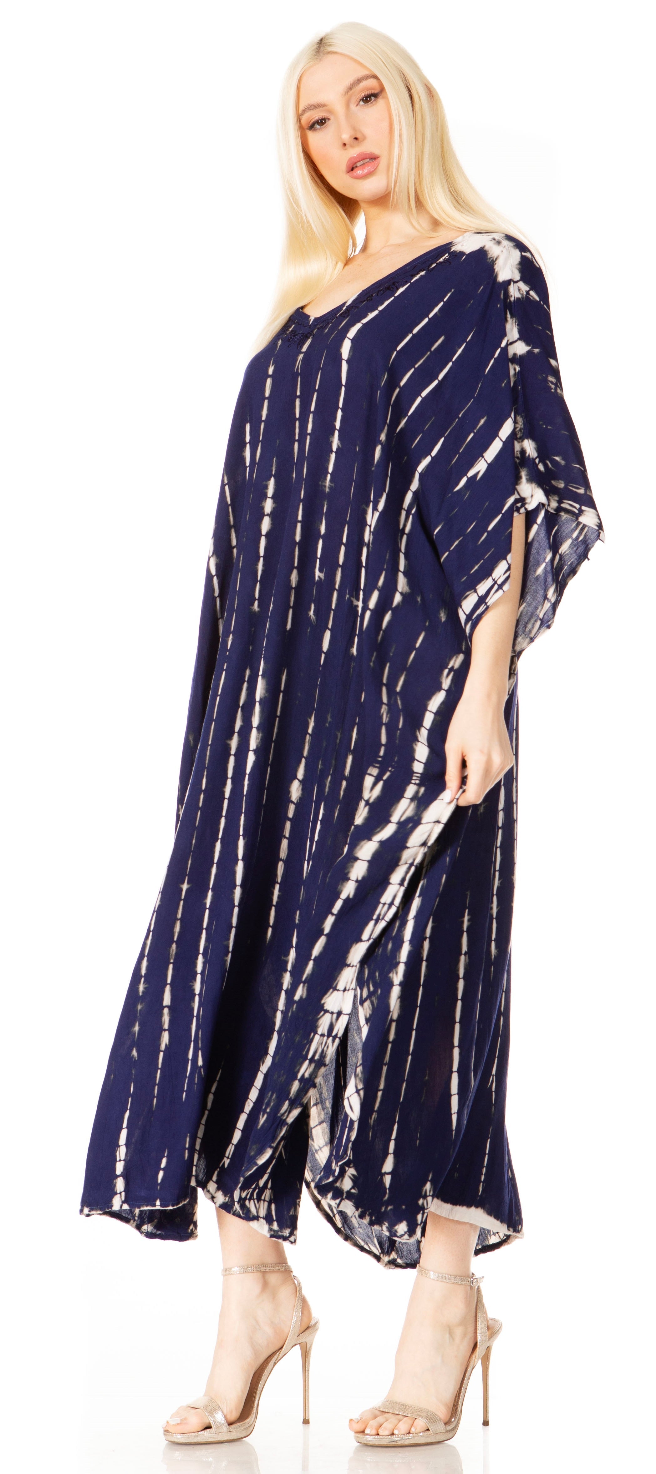 Woman wearing a navy tie-dye dress with a white background