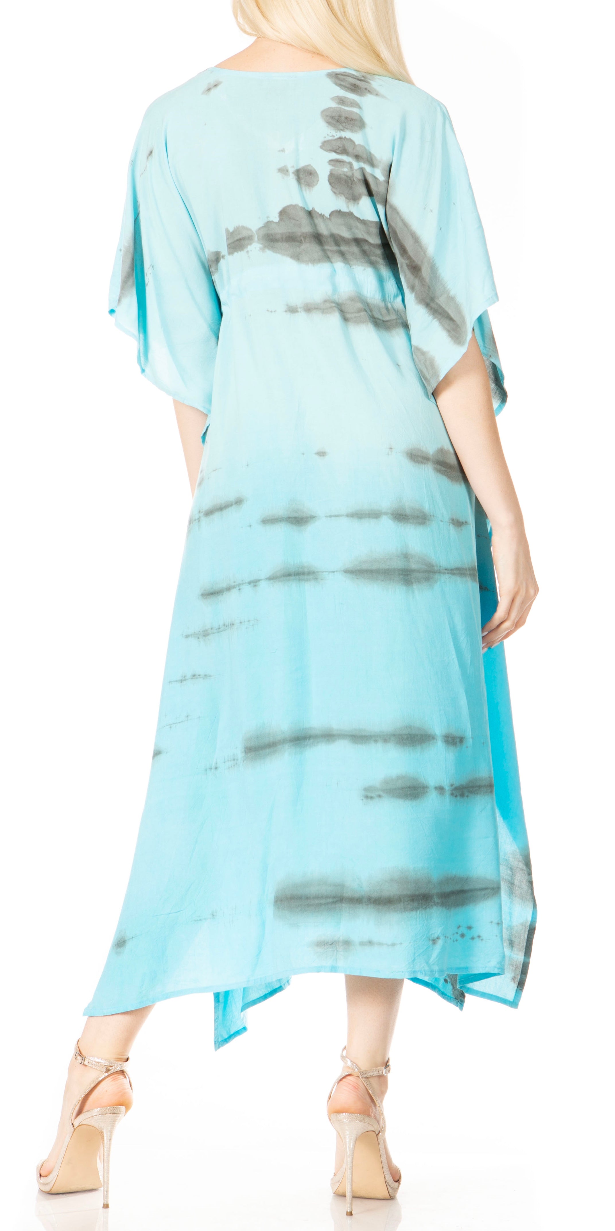 Woman wearing a light blue tie-dye dress with a white background