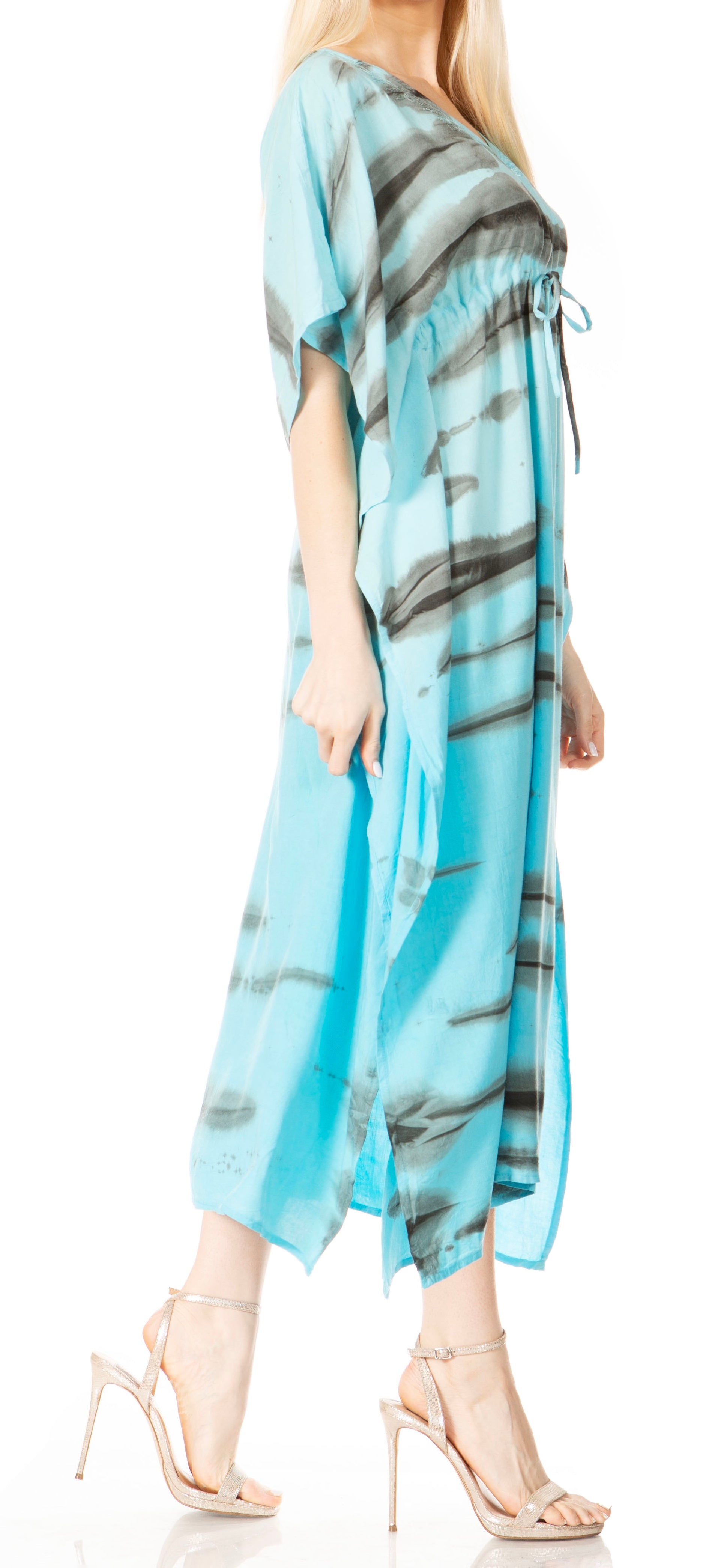 Woman wearing a blue and gray patterned dress with high heels on a white background