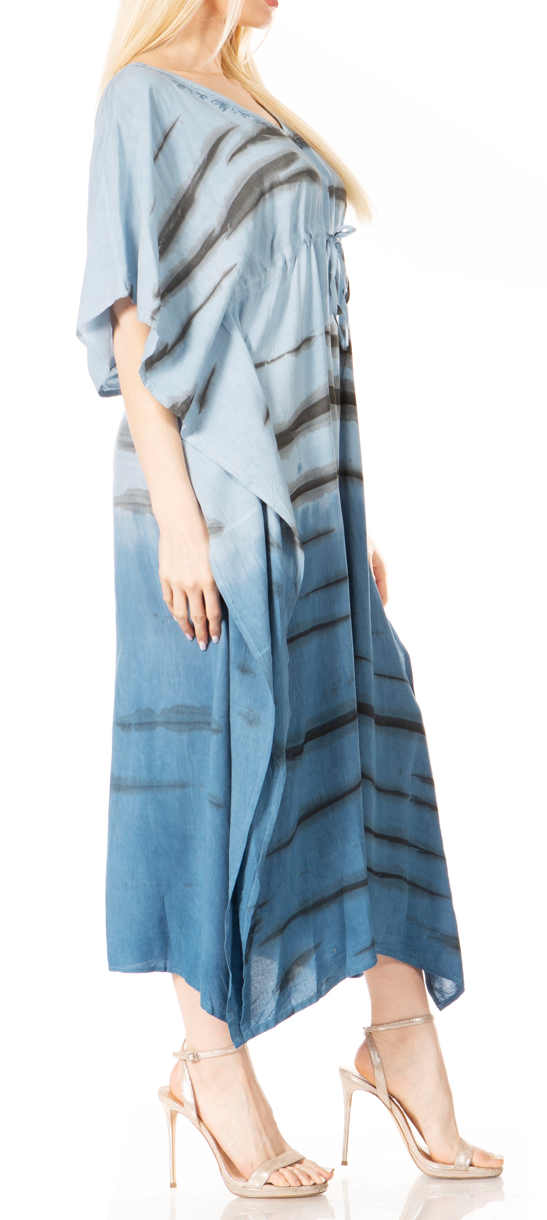 Woman wearing a blue dress with black abstract patterns on a white background
