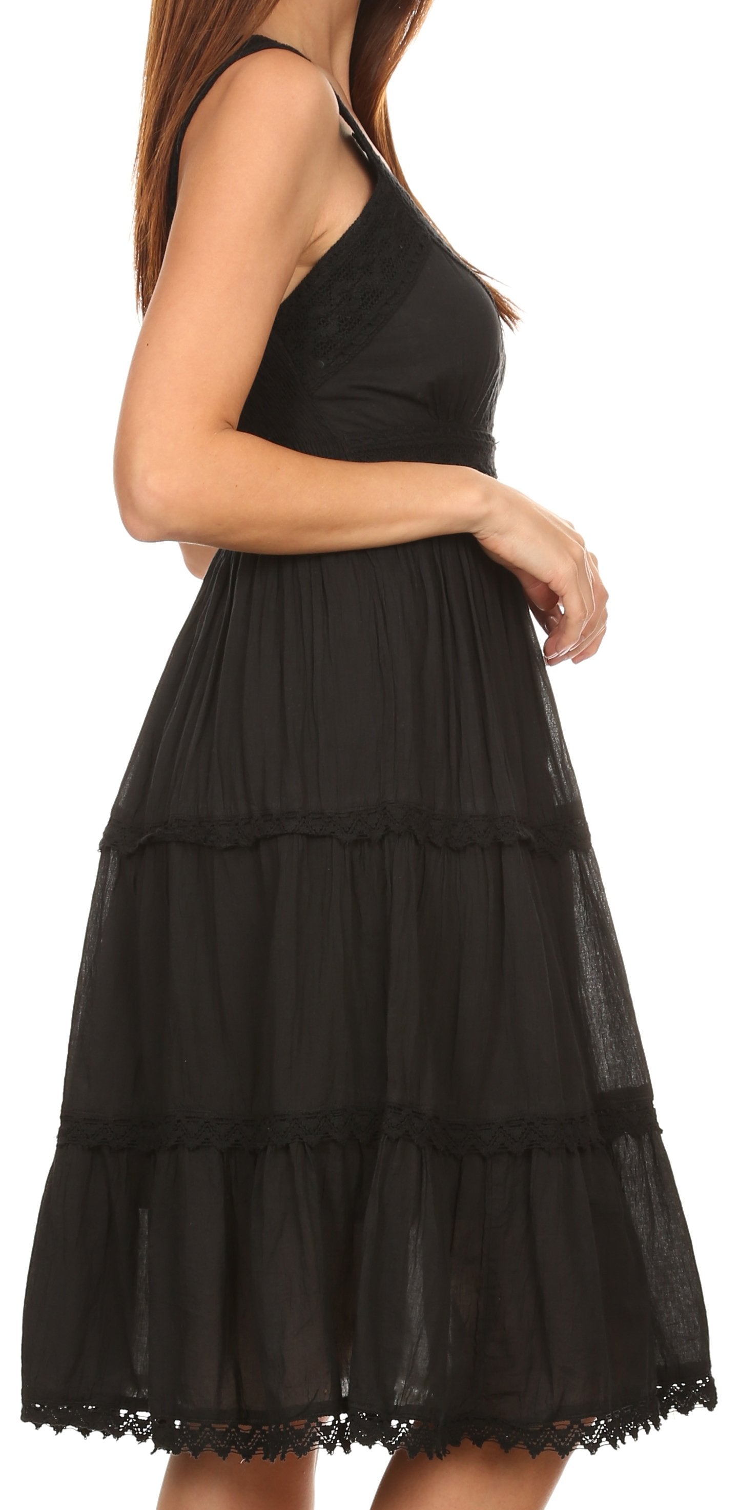 Black tiered dress worn by a model on a white background