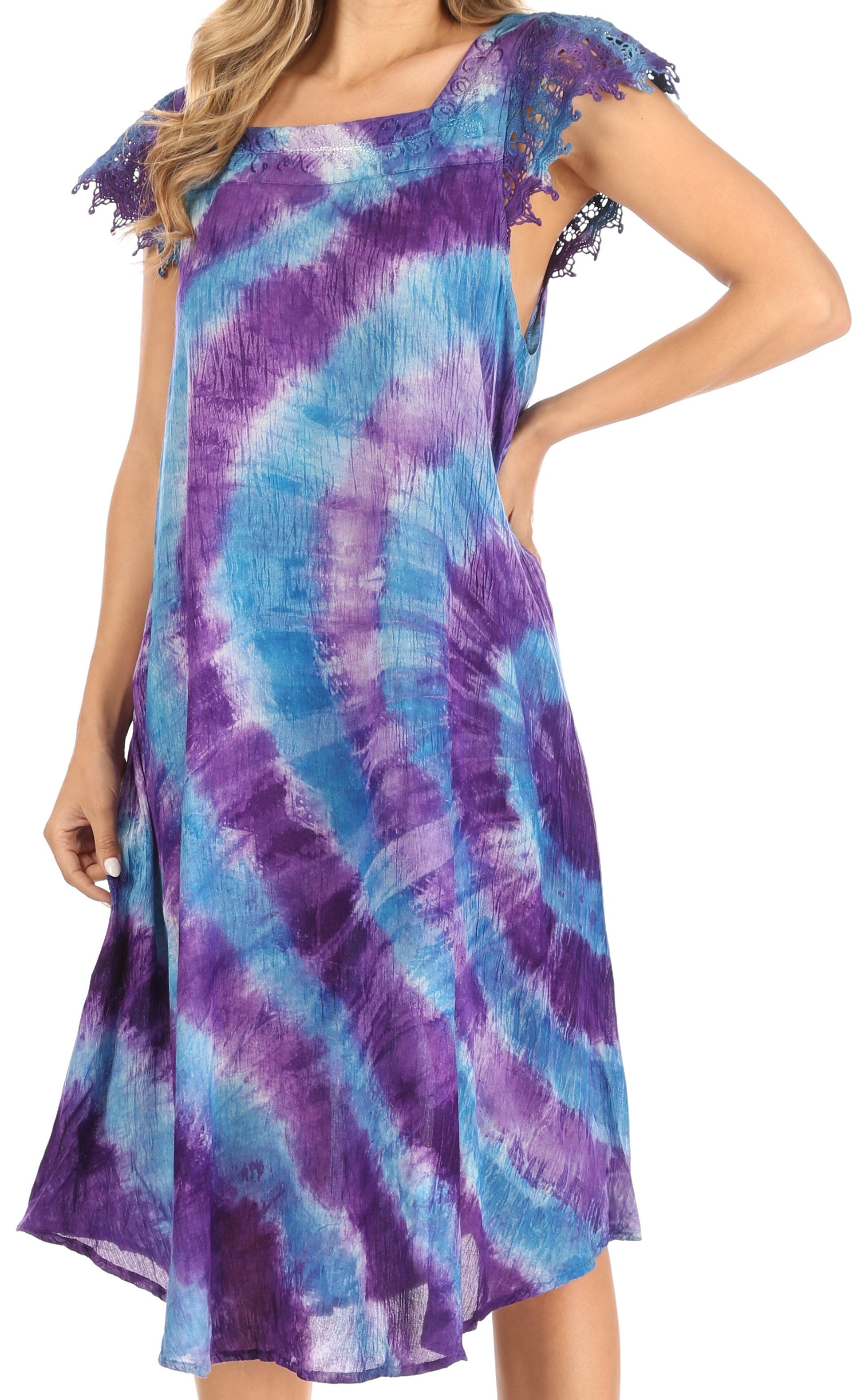 Woman wearing a tie-dye dress with purple and blue patterns on a white background