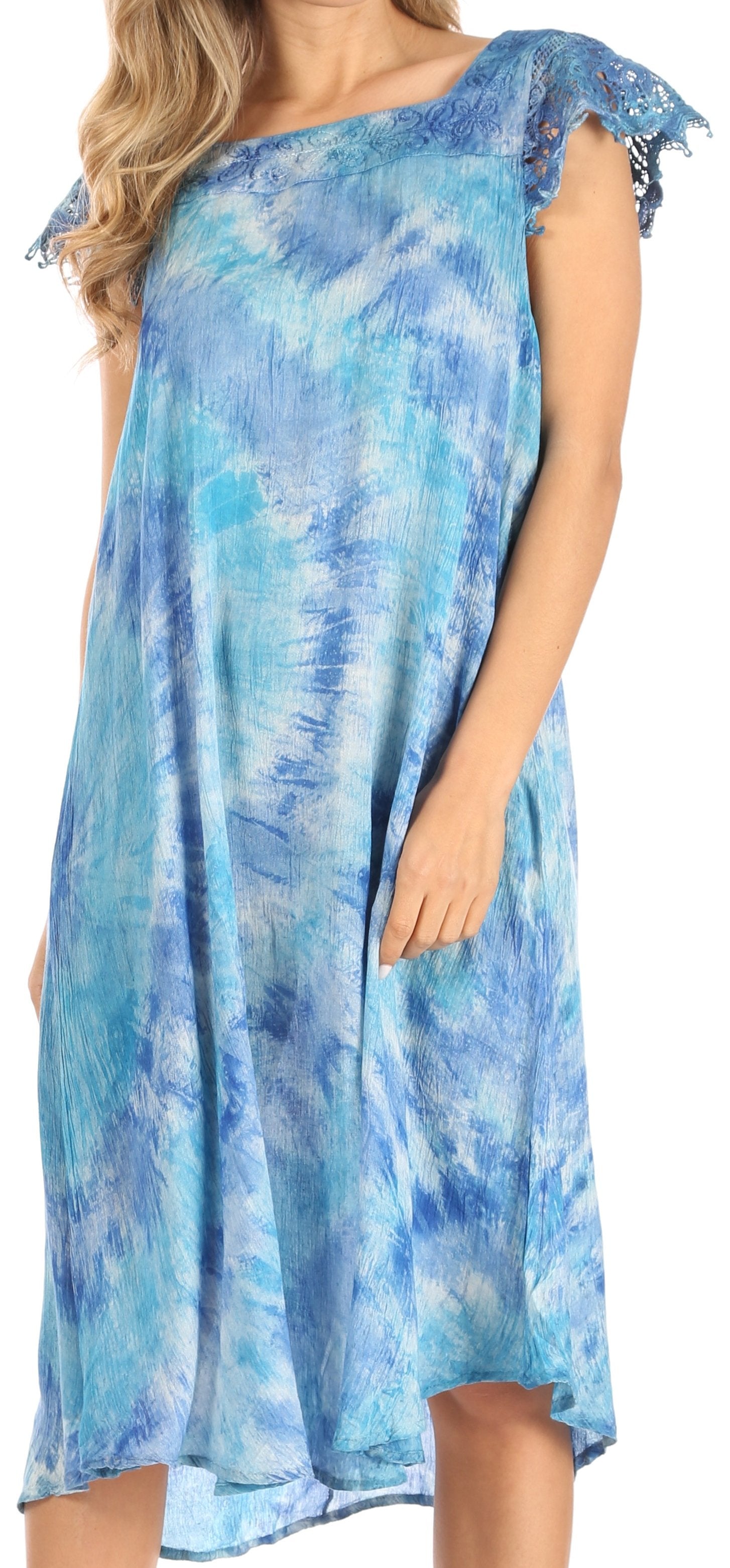 Woman wearing a blue tie-dye dress with lace sleeves.