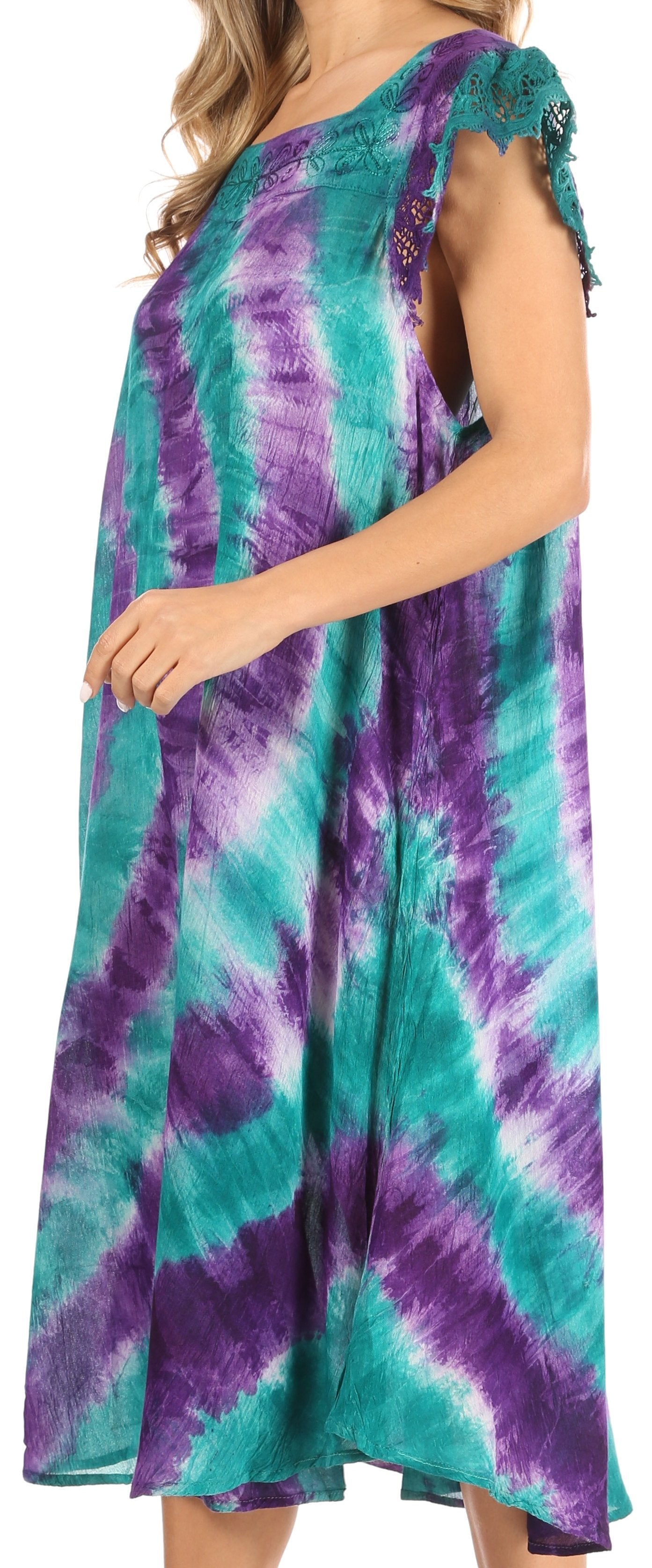 Woman wearing a tie-dye dress with purple and teal colors on a white background