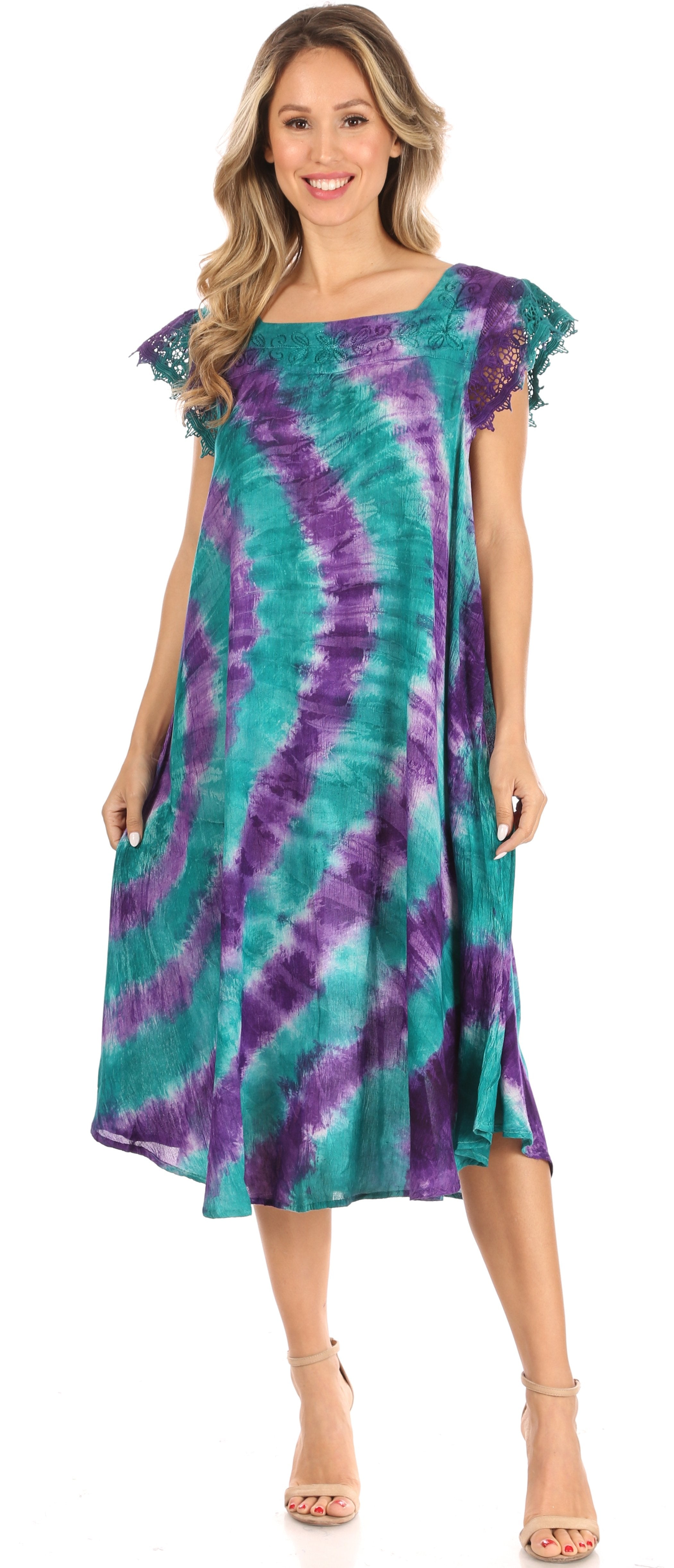 Woman wearing a tie-dye dress with purple and green patterns on a white background