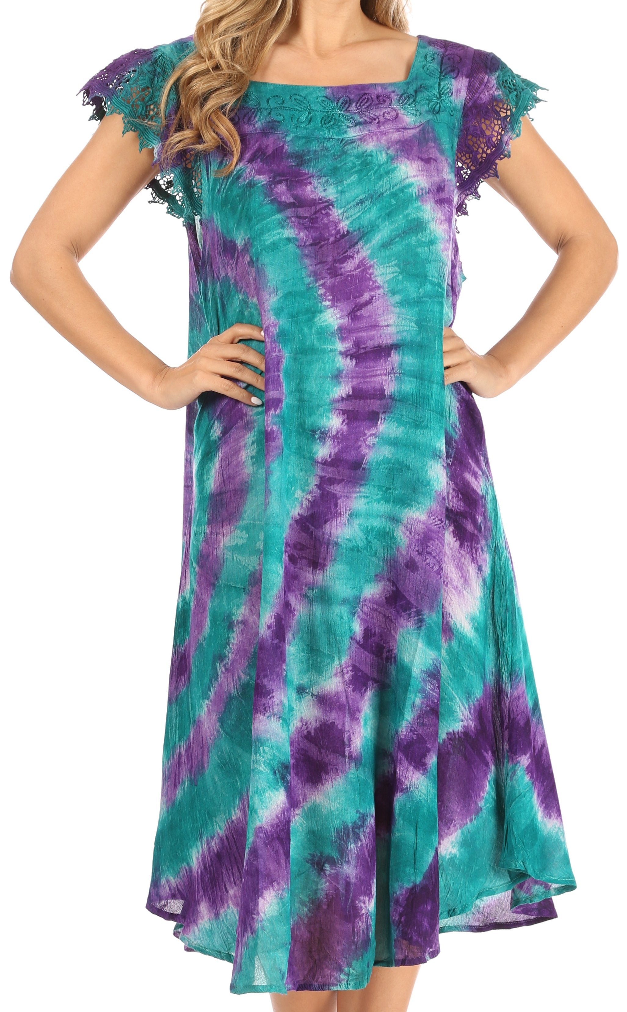Woman wearing a tie-dye dress with purple and teal patterns on a white background