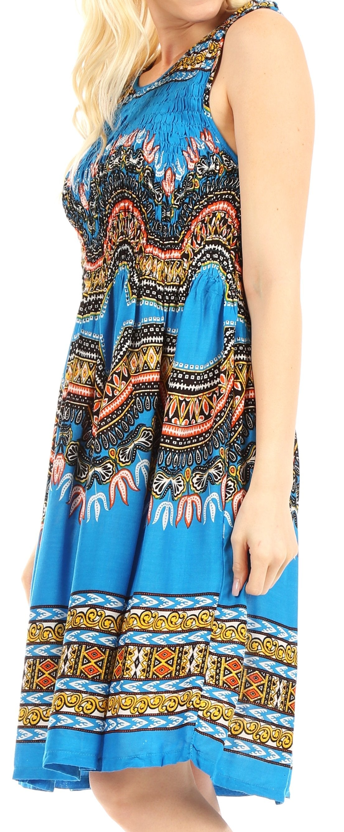 Woman wearing a sleeveless dress with a colorful pattern on a blue background