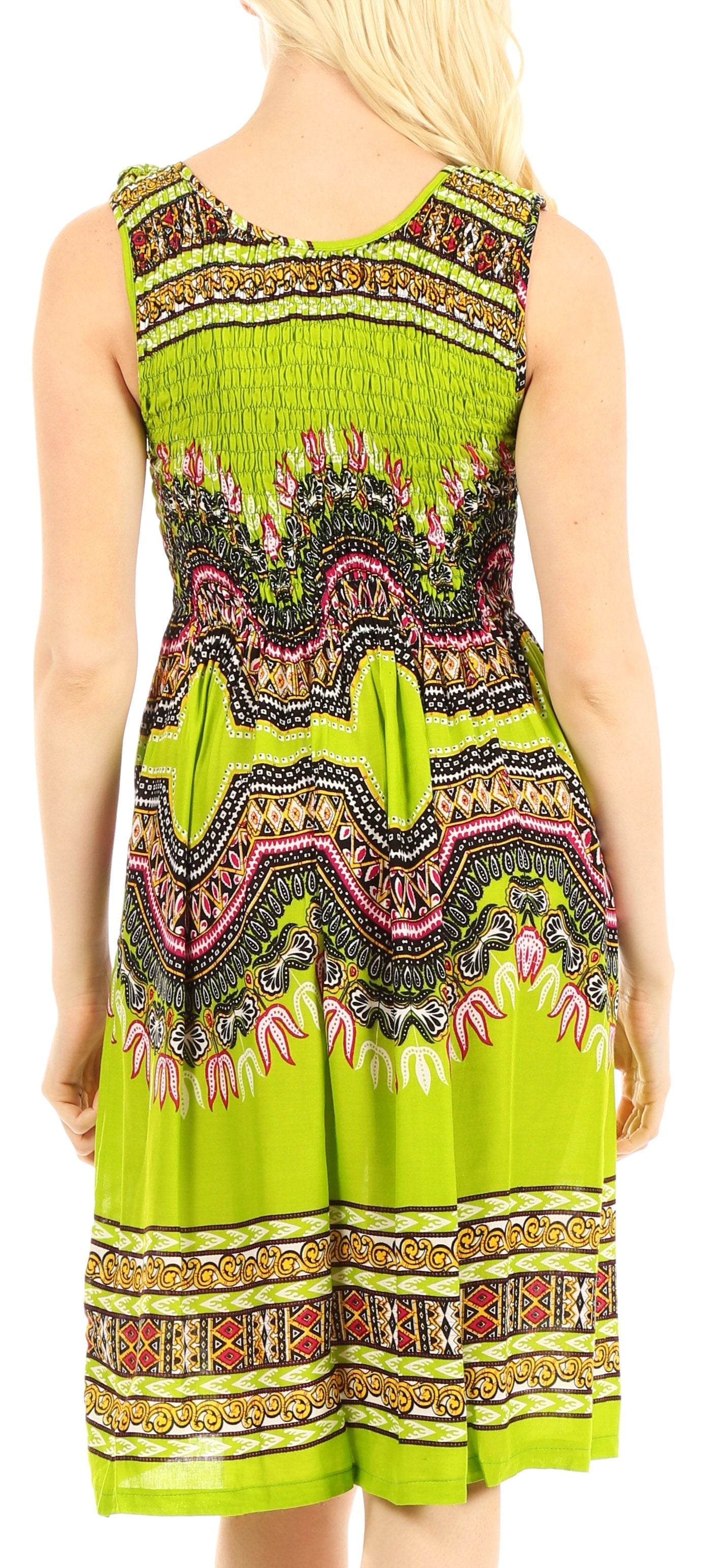 Woman wearing a green patterned dress with a colorful design.