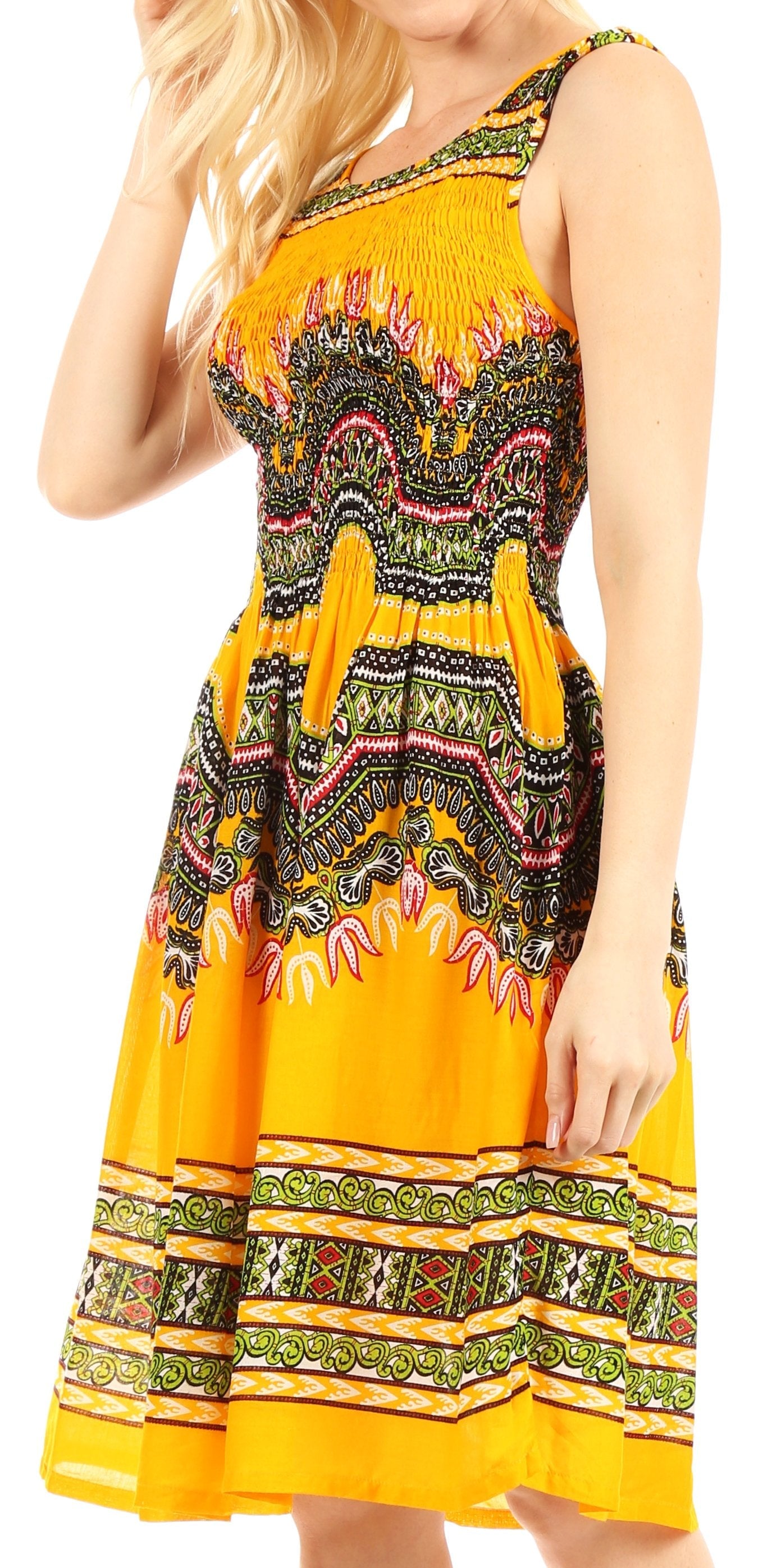 Woman wearing a yellow dress with colorful patterns on a white background