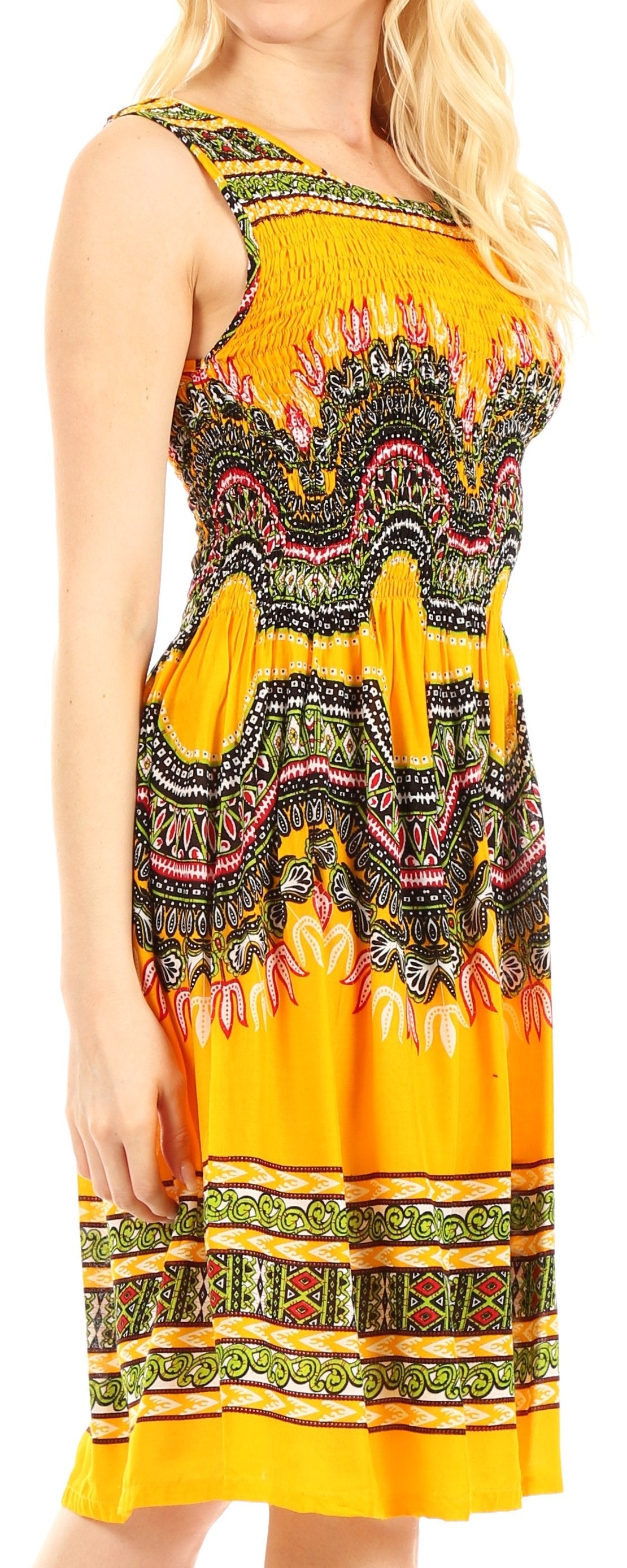 Woman wearing a sleeveless dress with a colorful pattern on a plain background
