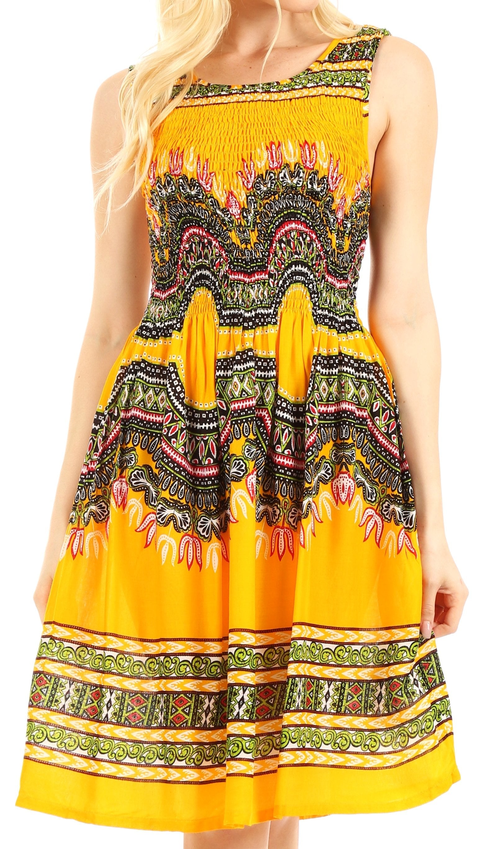 Woman wearing a yellow dress with intricate patterns on a white background