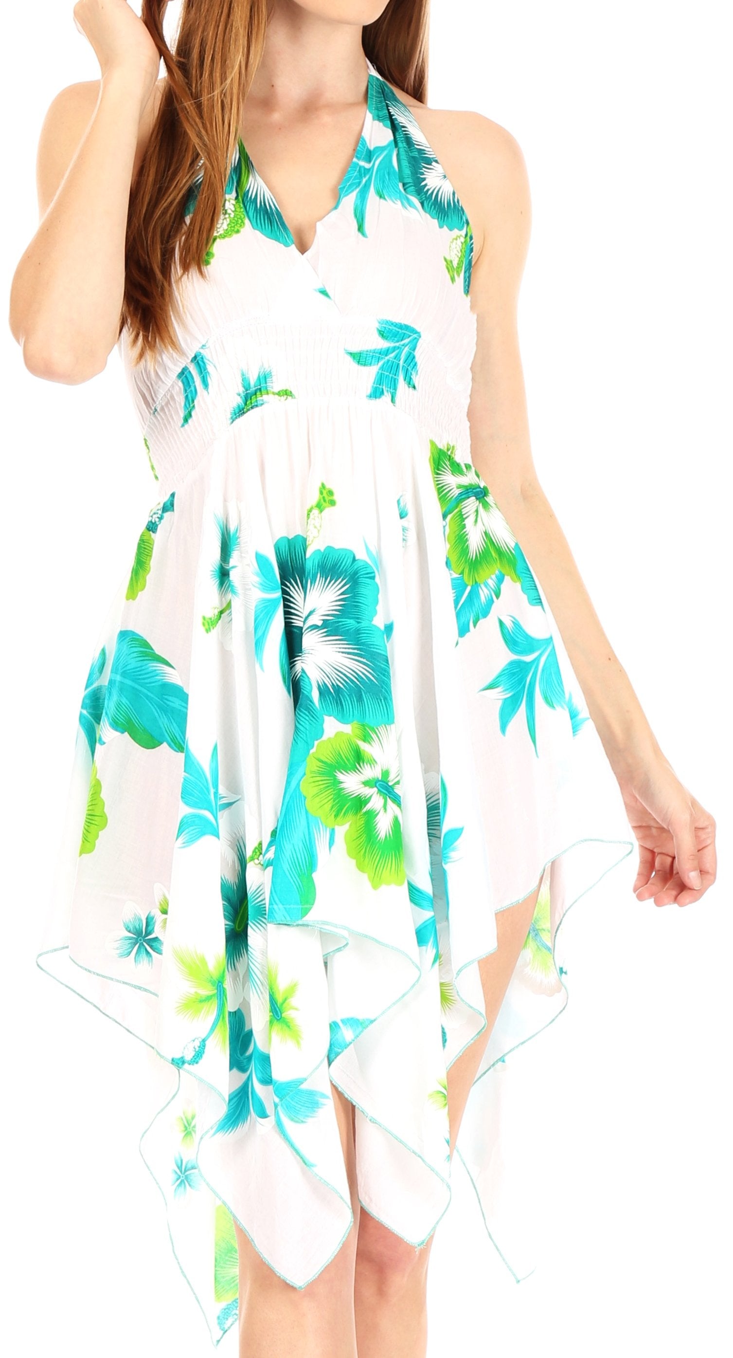 Woman wearing a floral dress with blue and green patterns on a white background