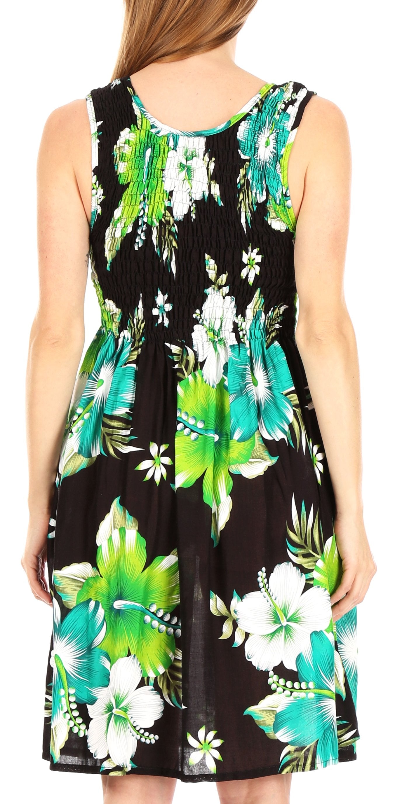 Woman wearing a sleeveless dress with tropical floral pattern on a white background