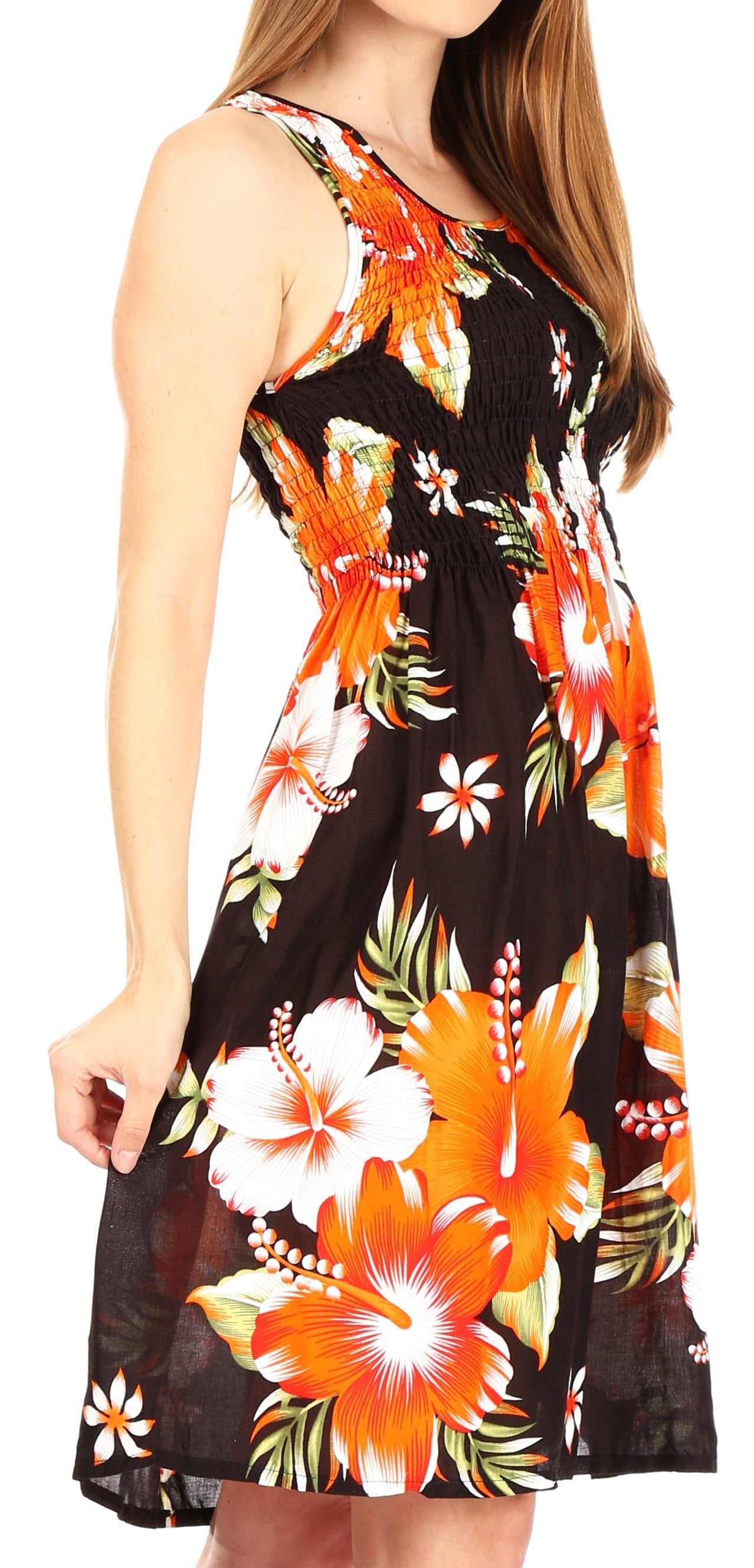 Woman wearing a sleeveless dress with a tropical floral pattern on a white background