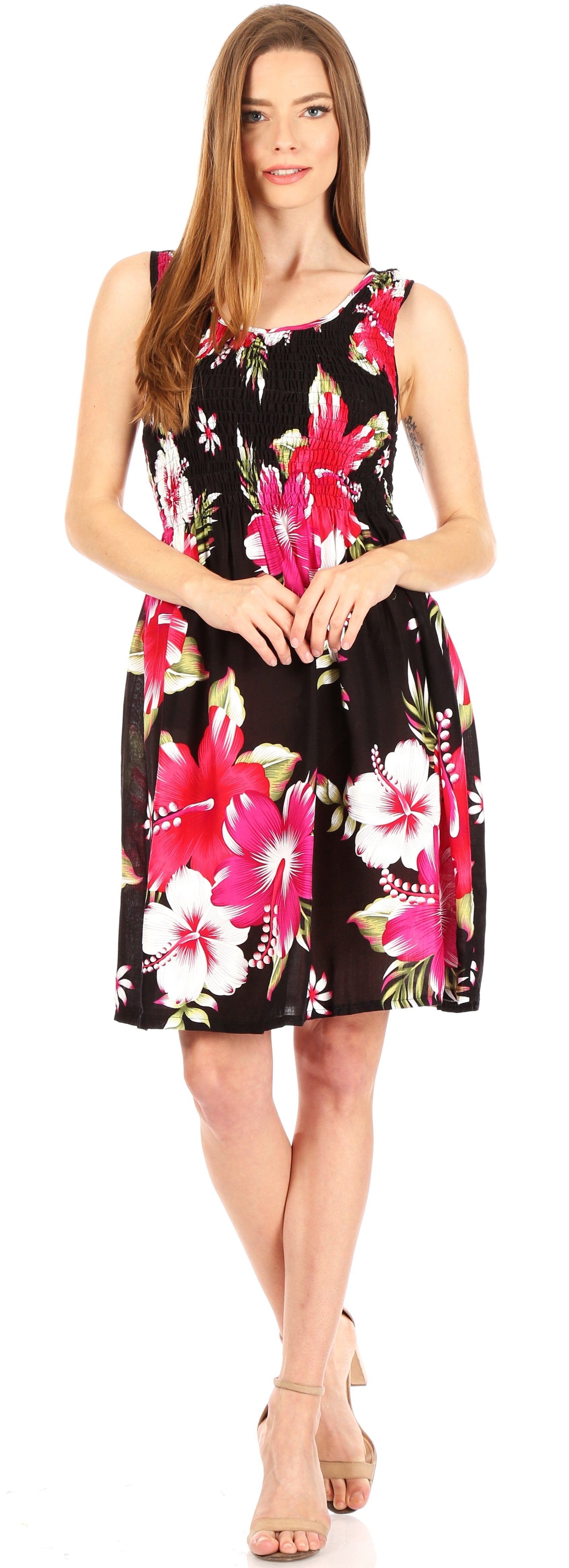Woman wearing a sleeveless floral dress with a black background