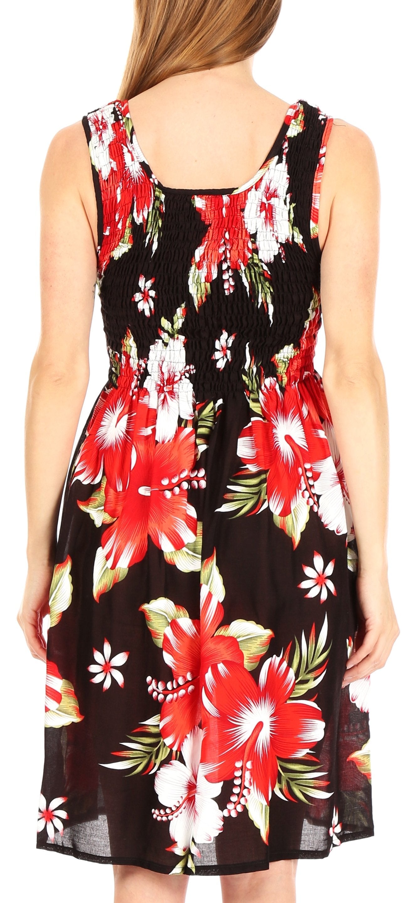Woman wearing a sleeveless dress with a colorful floral pattern on a black background