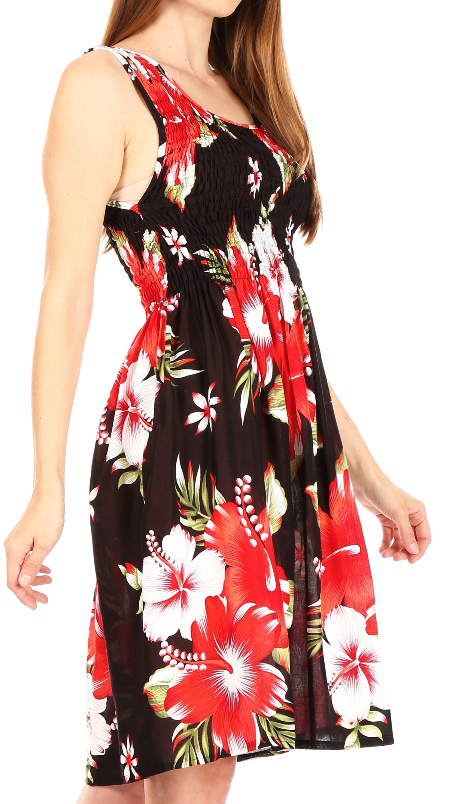 Woman wearing a sleeveless dress with a colorful floral pattern on a white background