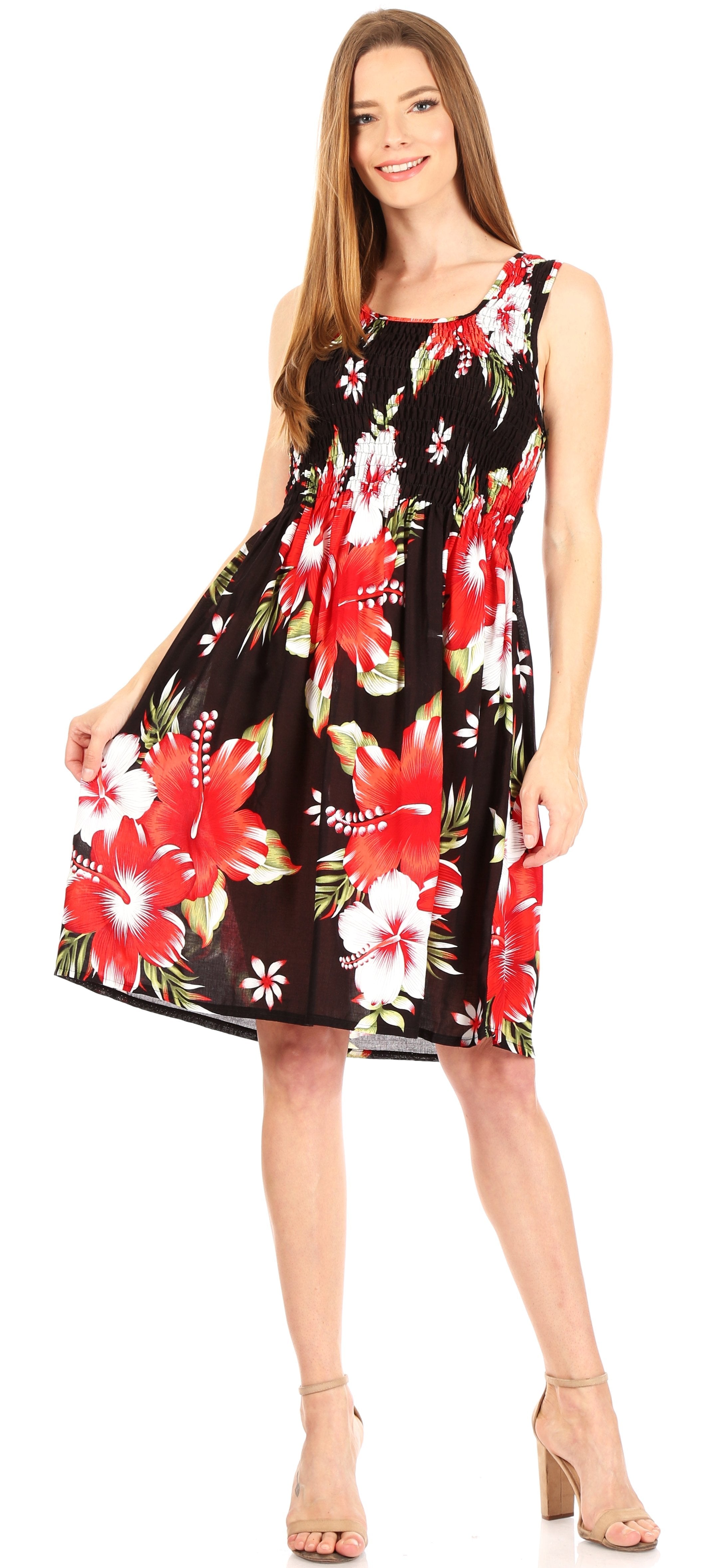 Woman wearing a black floral dress with red and white flowers on a white background