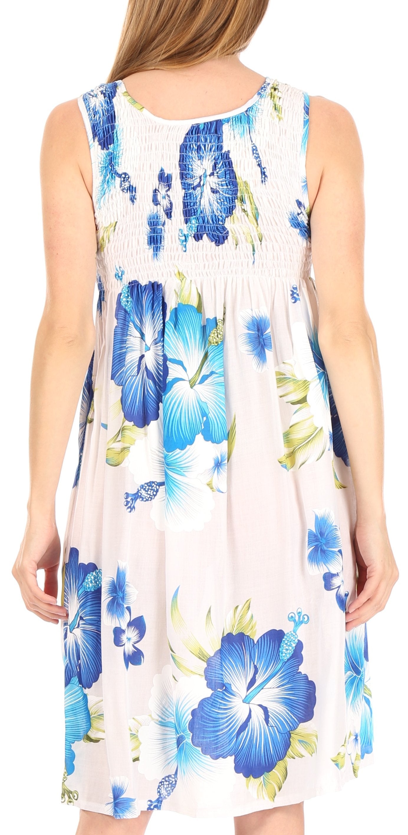 Woman wearing a sleeveless dress with blue floral pattern on a white background