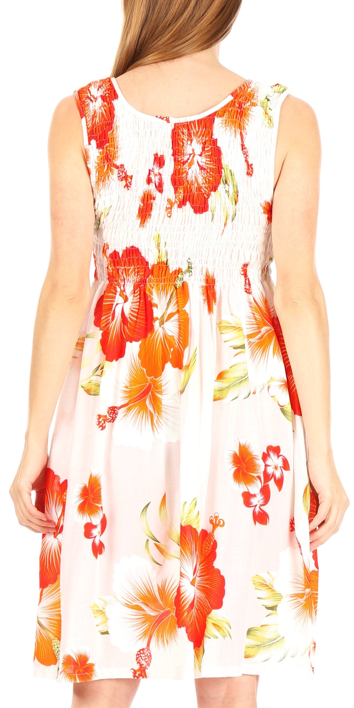 Woman wearing a sleeveless dress with orange floral pattern on a white background