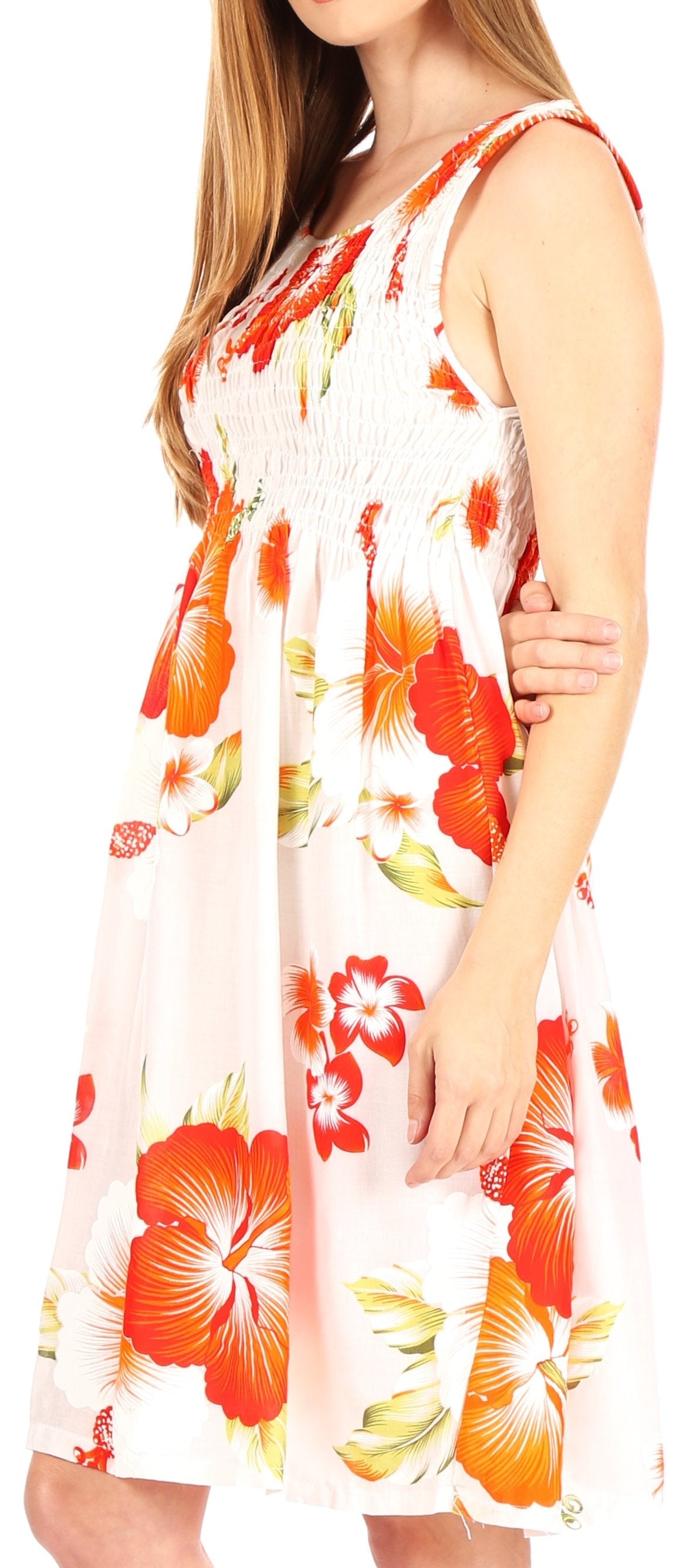 Woman wearing a sleeveless dress with red floral pattern on a white background