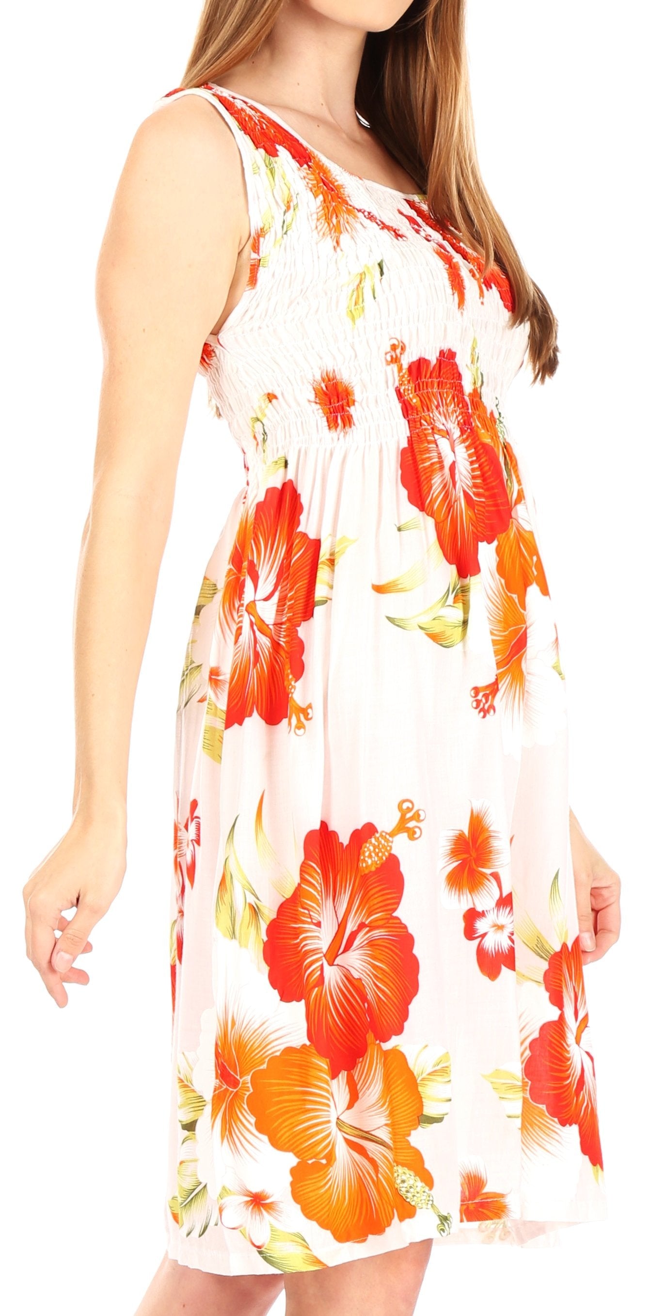 Woman wearing a sleeveless dress with orange floral pattern on a white background
