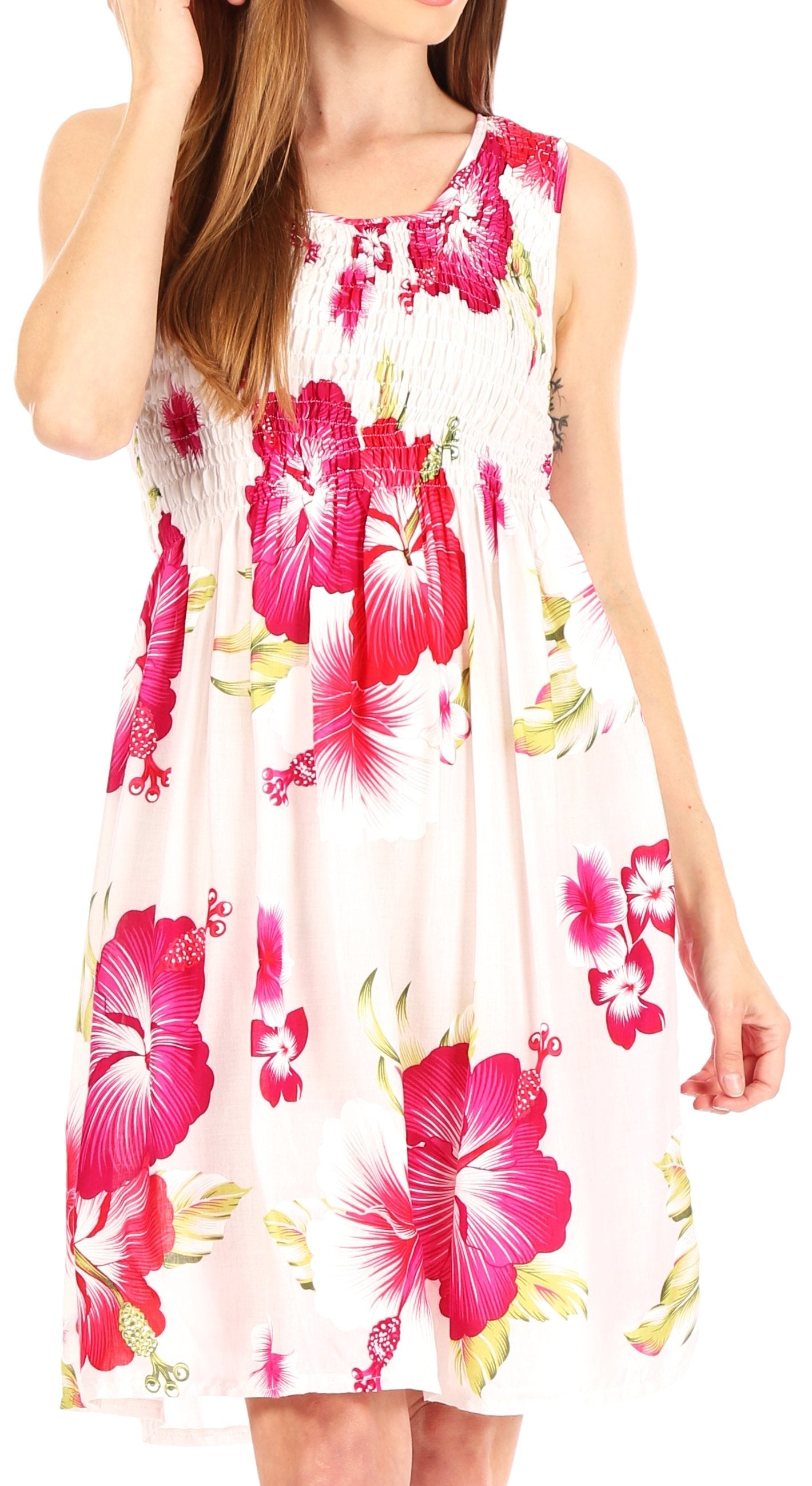 Woman wearing a sleeveless dress with pink floral pattern on a white background
