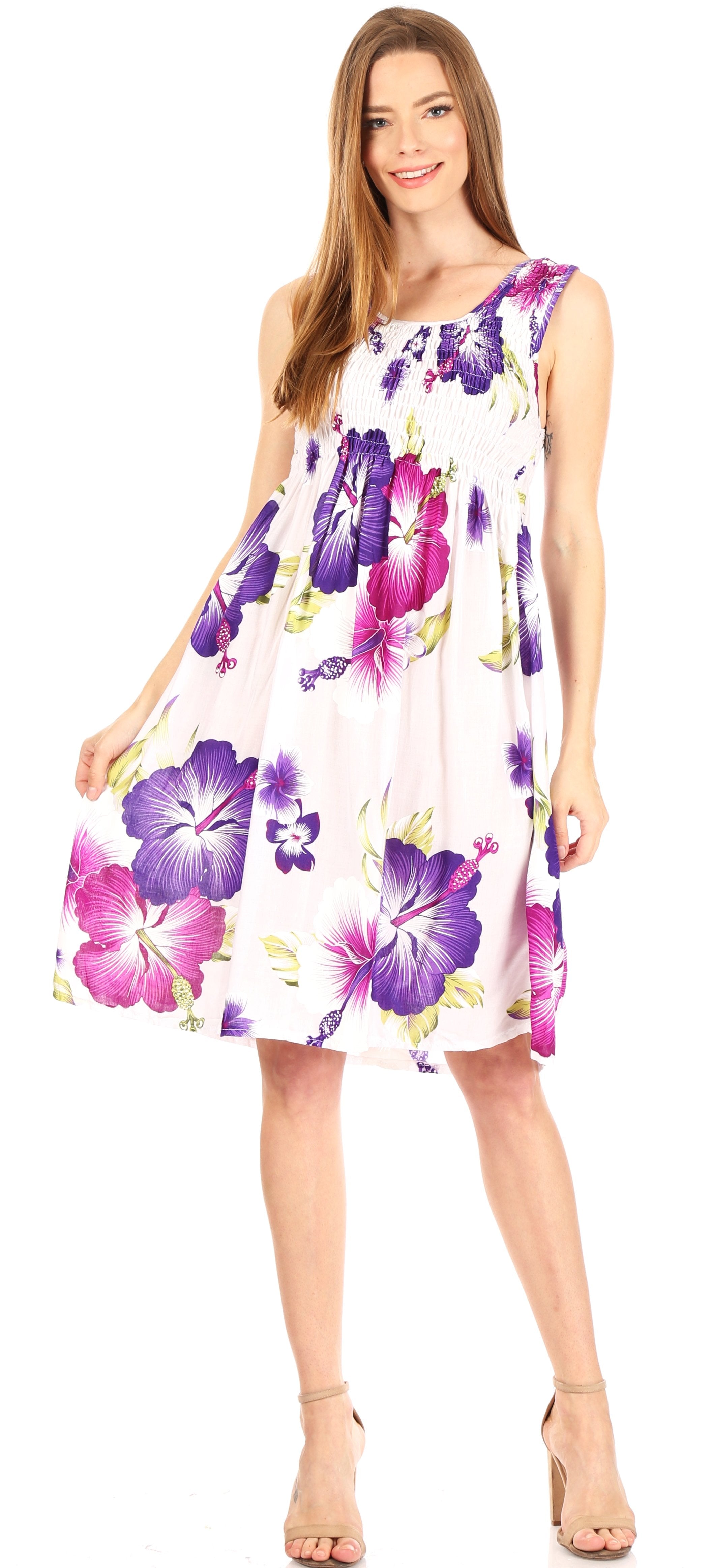 Woman wearing a floral dress with purple and pink flowers on a white background