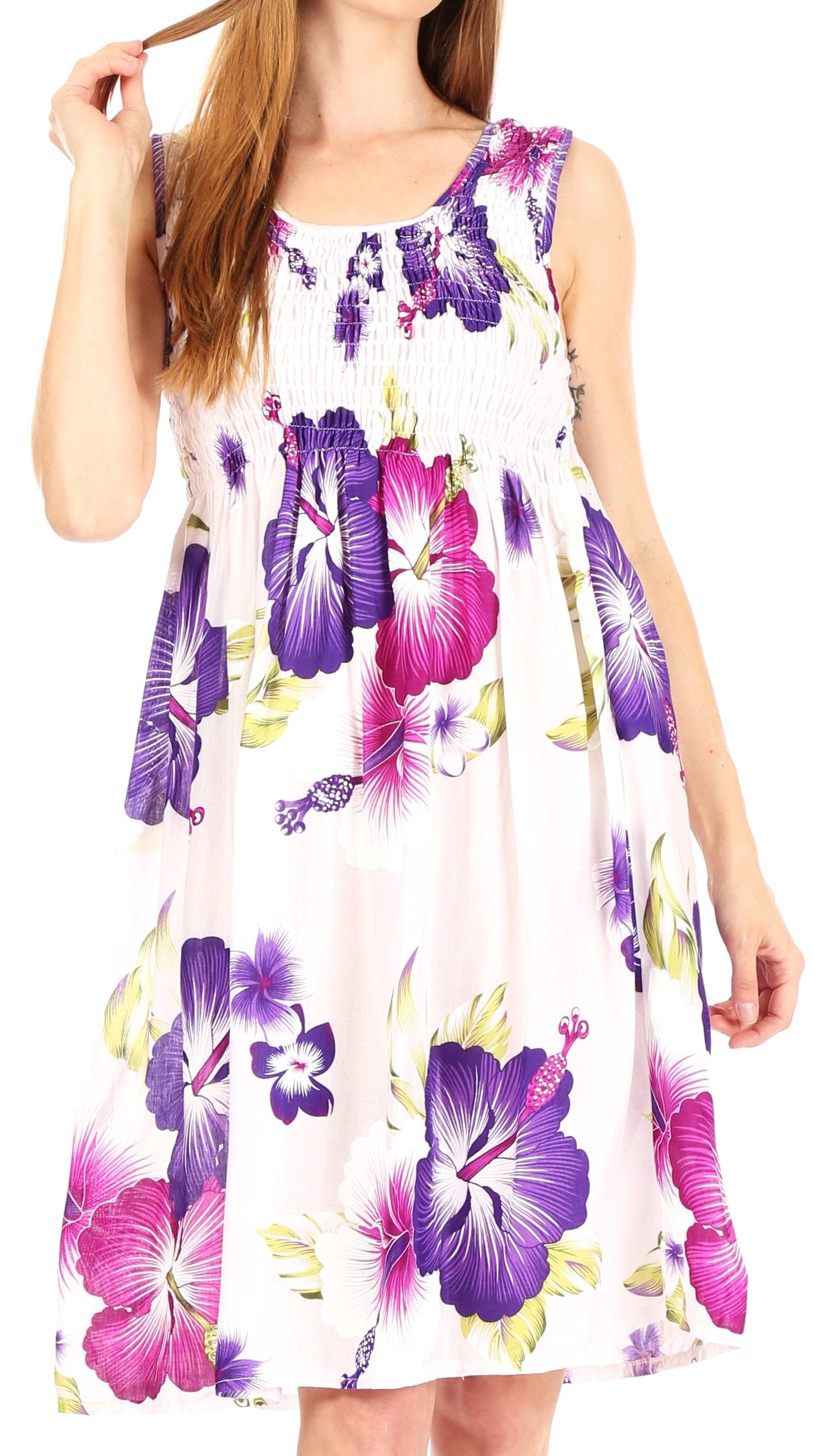 Woman wearing a sleeveless dress with purple and pink floral pattern on a white background