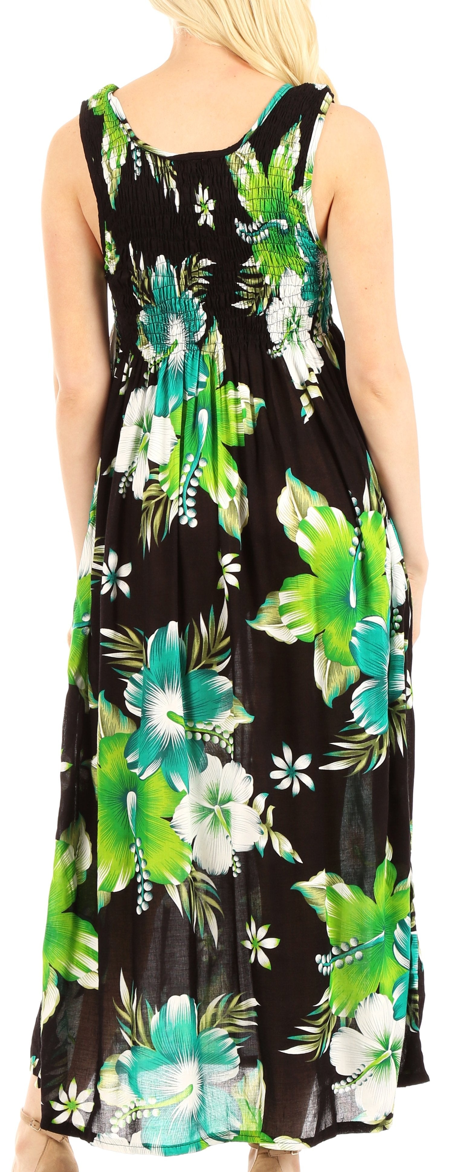 Woman wearing a sleeveless dress with green floral pattern on a black background