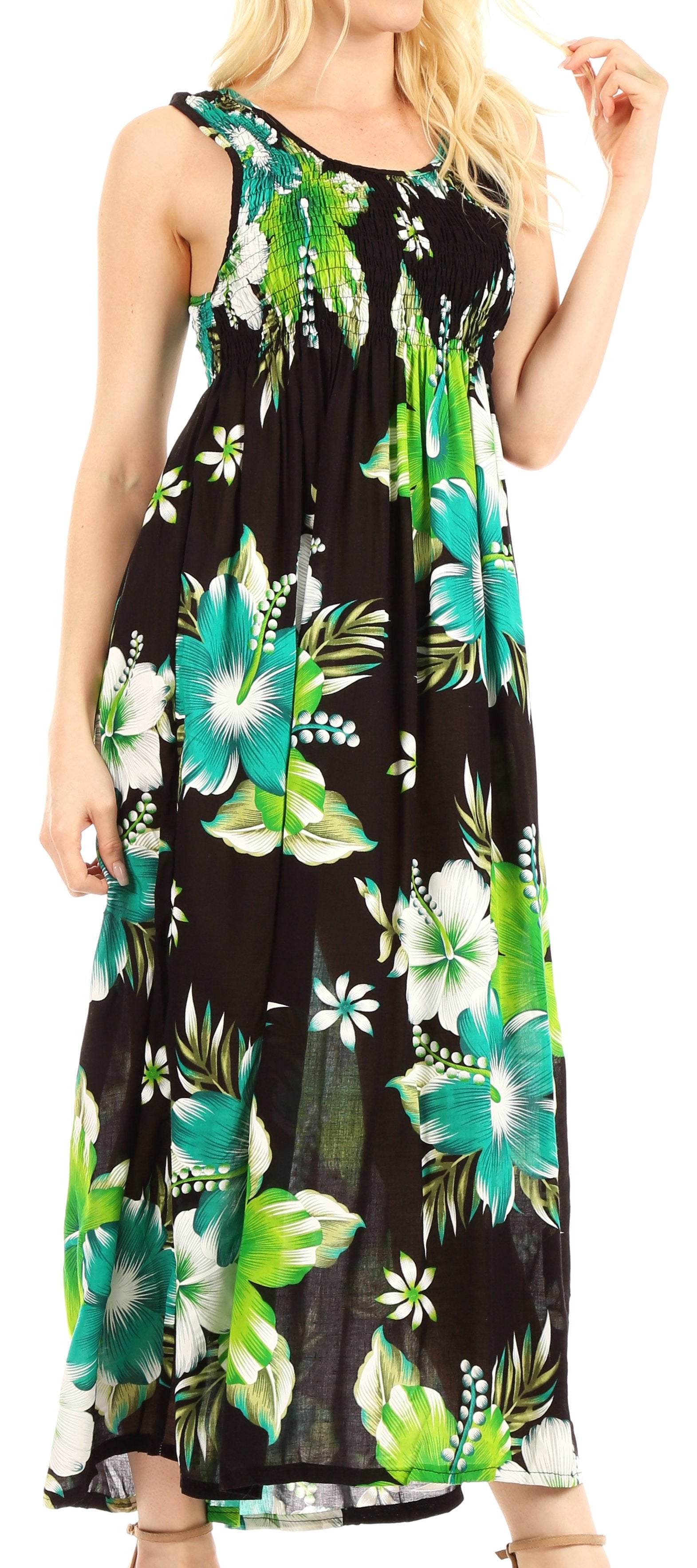Woman wearing a sleeveless dress with tropical floral pattern on a black background