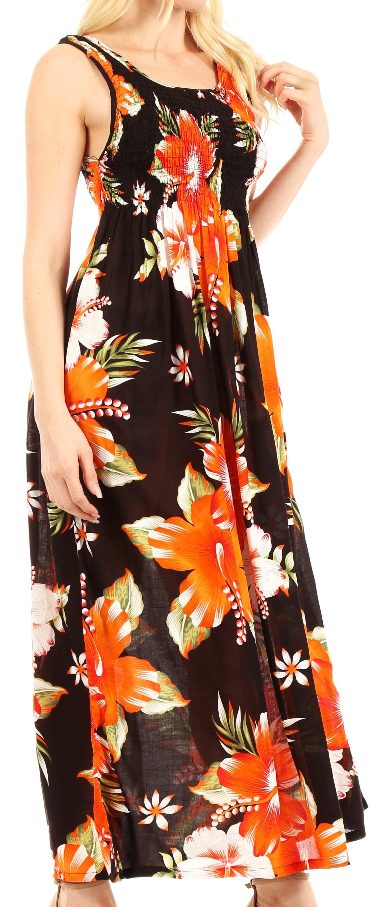 Woman wearing a black floral dress with orange and green flowers.