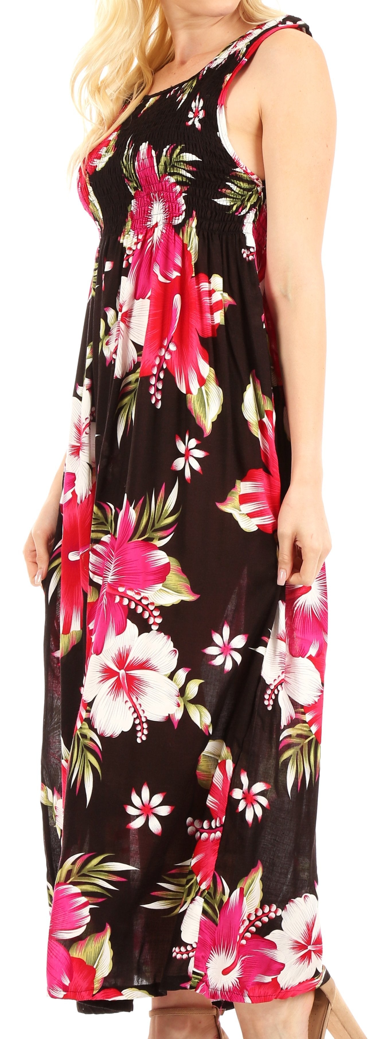 Woman wearing a sleeveless floral dress with pink and white flowers on a black background.