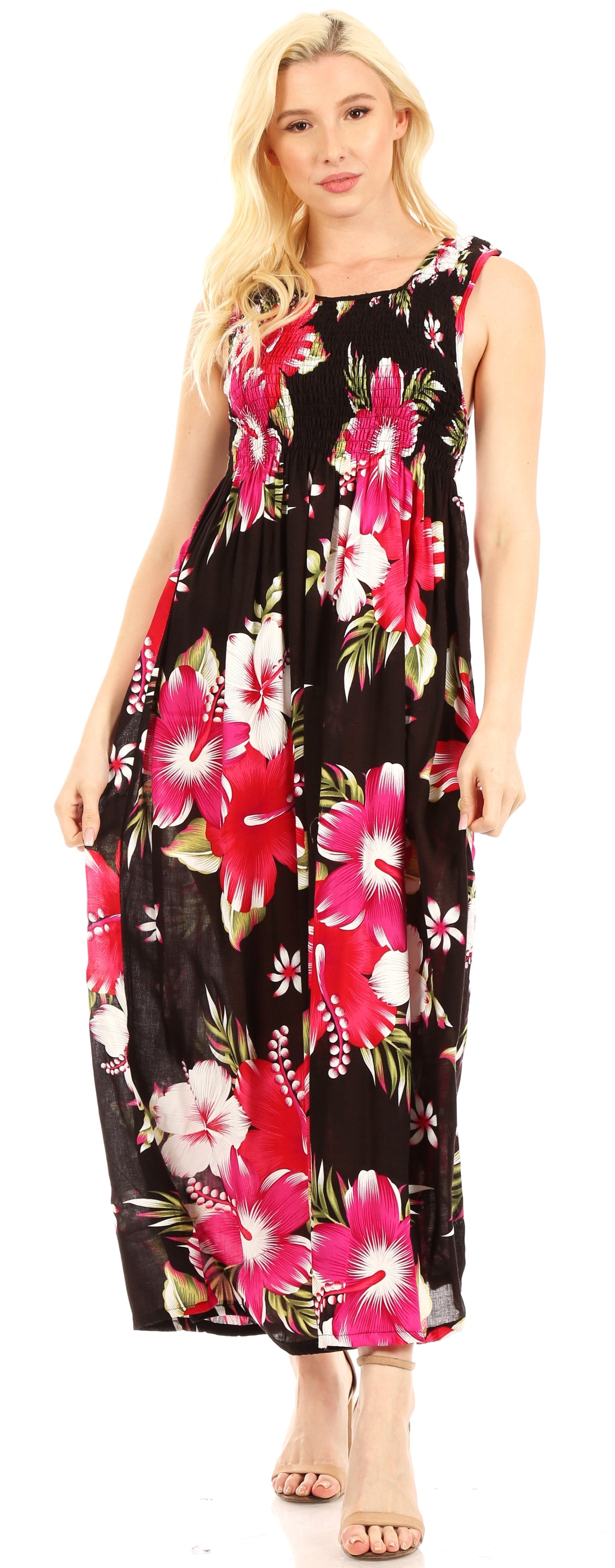Woman wearing a black floral dress with pink and white flowers on a plain background