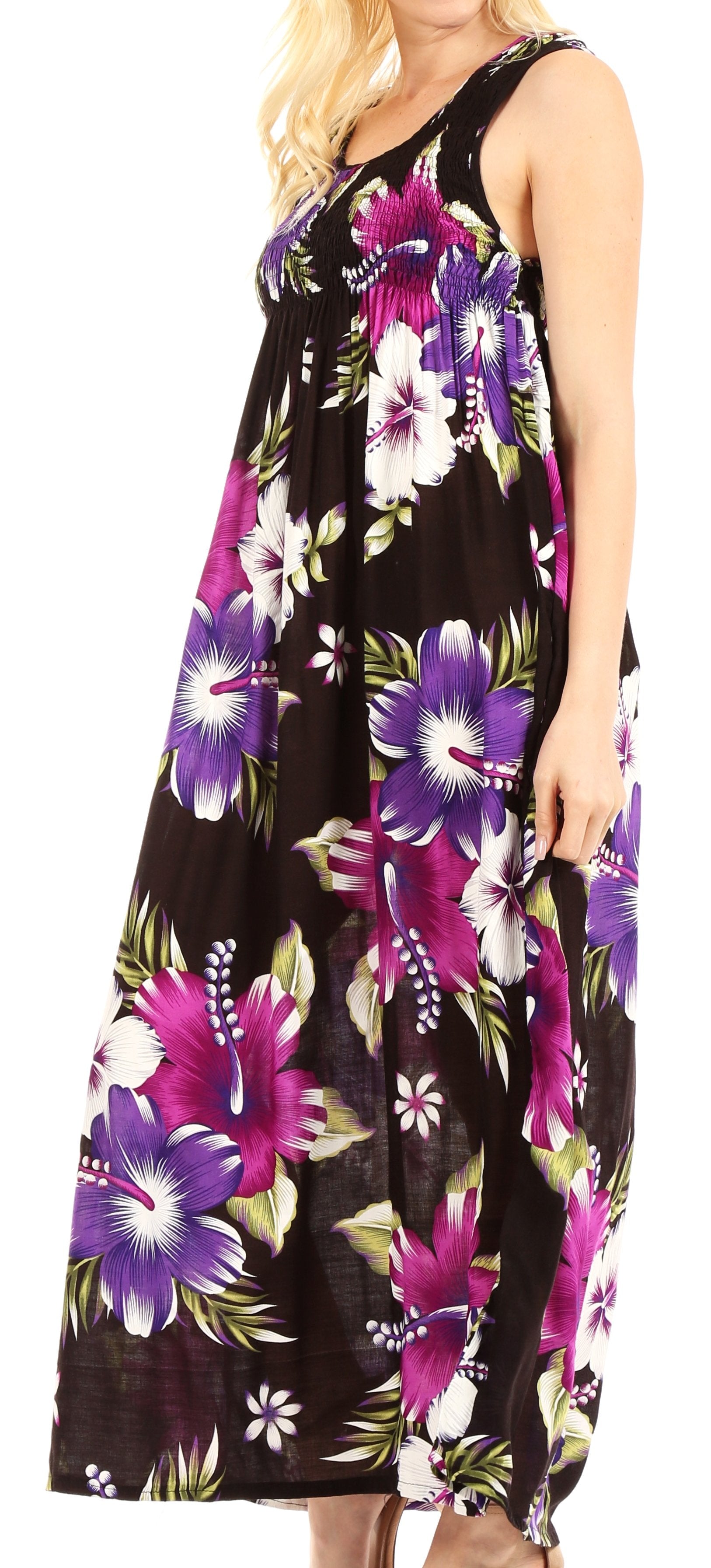 Woman wearing a sleeveless dress with a floral pattern on a black background