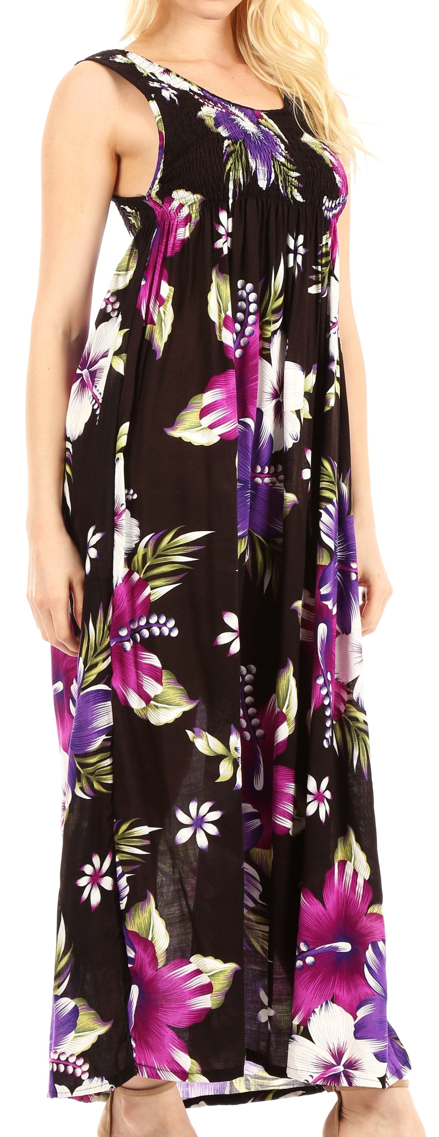 Woman wearing a sleeveless dress with floral pattern on a plain background