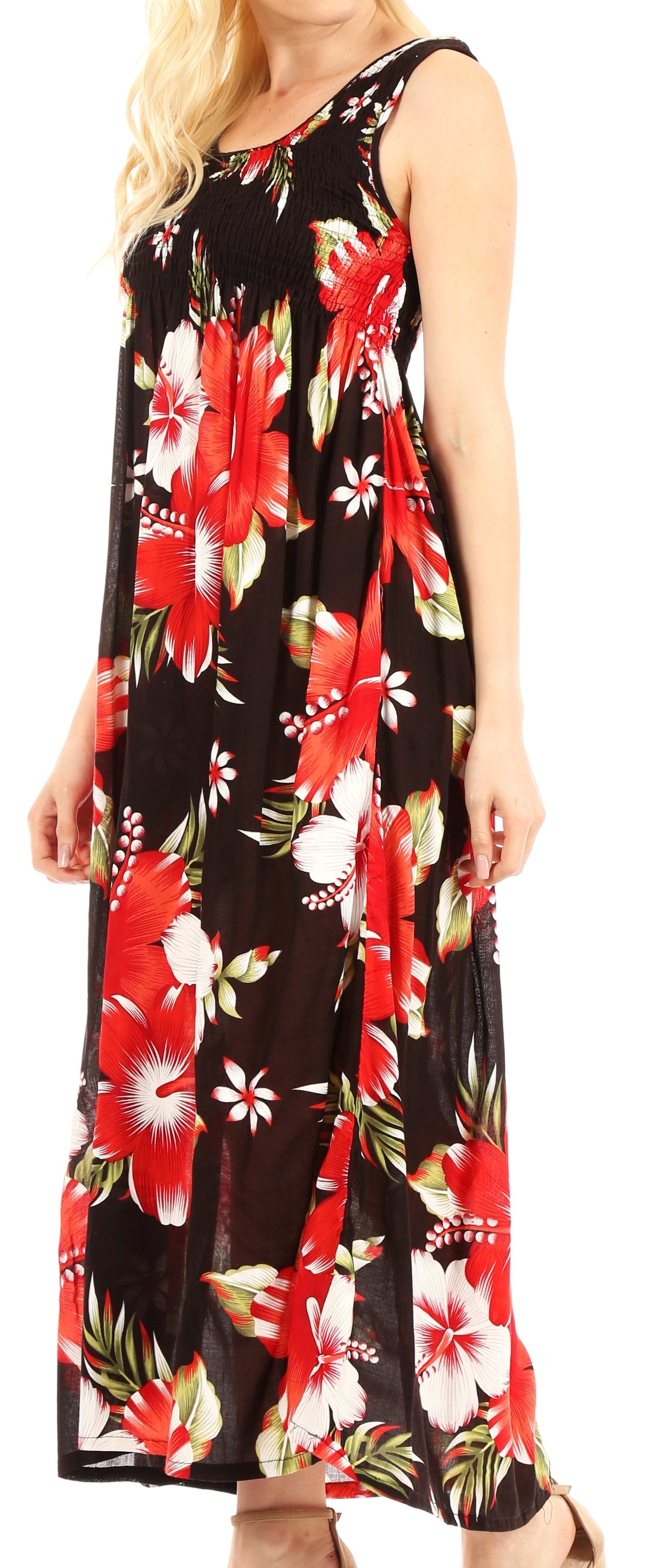 Woman wearing a sleeveless dress with a floral pattern on a black background