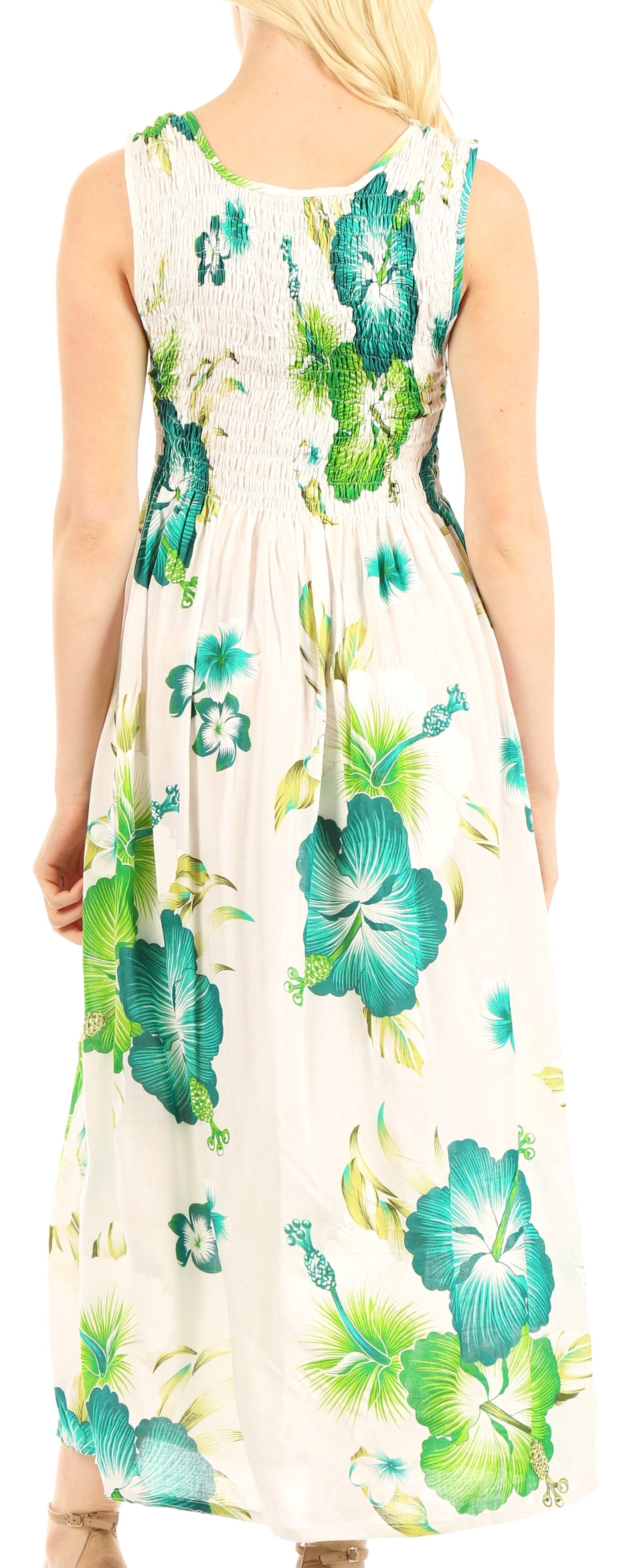 Woman wearing a floral dress with green and blue flowers on a white background